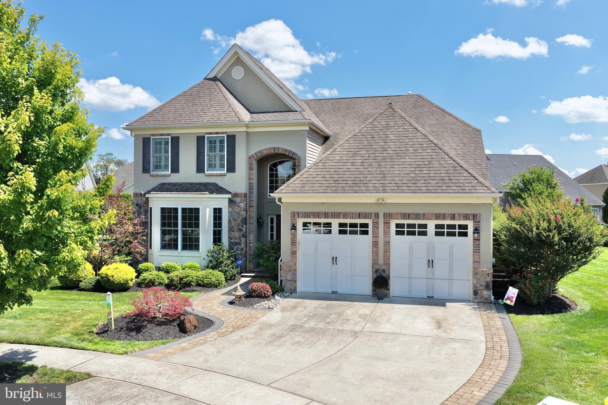 Welcome to 20 Liverpool Way, an exceptional residence situated within the prestigious Wyngate community of Medford, New Jersey. One of the largest and most impressive models offered in the community, this 3500sq ft meticulously maintained home combines sophisticated design, extensive custom upgrades, and an extraordinary setting on one of Wyngate’s largest premium homesites—providing a level of space and privacy rarely found within the neighborhood. From the moment you enter, the quality and attention to detail are immediately apparent. Soaring ceilings, rich wood flooring, custom millwork, crown molding, wainscoting, plantation shutters, and designer window treatments create an elegant yet inviting atmosphere throughout the home. The dramatic two-story family room serves as a stunning centerpiece, featuring a beautiful gas fireplace and walls of natural light. The adjoining gourmet kitchen is equally impressive, showcasing gorgeous cabinetry, a custom tiled backsplash, generous workspace, and a thoughtfully designed layout ideal for both intimate gatherings and entertaining. A bright and beautiful sunroom offers another exceptional living space while providing peaceful views of the private rear grounds. The highly desirable first-floor primary suite creates a luxurious private retreat and allows for effortless main-level living. Also located on the first floor is a handsome library/home office featuring beautiful custom built-ins—an impressive space equally suited for working from home or relaxing with a favorite book. The second level dramatically expands the versatility of the home, offering an additional living room, spacious bedroom, full bathroom, and a substantial bonus room that could easily be finished as a third bedroom, private office, fitness studio, media room, or additional guest suite. The exterior is equally impressive. Step outside to a beautifully designed rear patio complemented by attractive retaining walls and an expansive premium lot that provides exceptional privacy and a wonderful setting for outdoor entertaining. Completing the home is an oversized two-car garage and an extraordinary collection of thoughtful upgrades and architectural details throughout. Residents of Wyngate enjoy an exceptional resort-style lifestyle with access to a gorgeous clubhouse, swimming pool, tennis courts, and beautifully maintained community amenities. 20 Liverpool Way represents a rare opportunity to own one of Wyngate’s premier residences—exceptionally maintained, extensively upgraded, beautifully appointed, and positioned on one of the community’s most desirable homesites.
