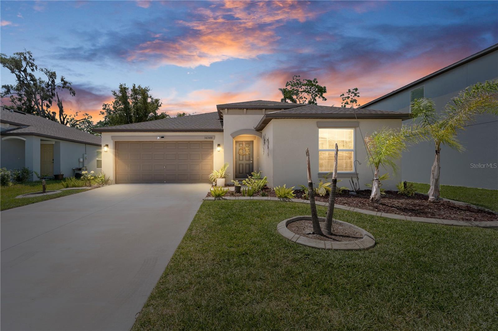 Step into this stunning, like-new 3-bedroom, 2.5-bath home in the sought-after community of Abbot Square! From the moment you walk in, you’ll appreciate the bright, open layout where the family room, dining area, and kitchen come together seamlessly—perfect for entertaining or everyday living. The kitchen is a standout feature, showcasing shaker-style cabinetry, granite countertops, stainless steel appliances, and a large center island that makes cooking and gathering effortless. Porcelain tile flooring flows through the main living areas, while the bedrooms offer cozy carpet for added comfort. The split floor plan provides privacy, with a spacious primary suite that feels like a true retreat. Enjoy a spa-inspired bathroom with a double vanity, ample storage, and a large walk-in closet enhanced with a custom Closet by Design system.Step outside to your own private escape, where the oversized lanai is perfect for relaxing or entertaining, overlooking a fully fenced backyard with plenty of space for activities, complemented by outdoor pavers, a stylish pergola, and lush landscaping that creates a peaceful setting.Complete with a 2-car garage offering flexibility for storage or additional needs, this home combines modern finishes, thoughtful design, and inviting outdoor living—all in one impressive package.Located in the master-planned community of Abbott Square, residents enjoy resort-style amenities including a pool, clubhouse, fitness center, playground, walking trails, and outdoor spaces with grilling areas. The low HOA fee includes high-speed internet for added convenience. Ideally situated in Zephyrhills, just minutes from Wesley Chapel, you’ll have easy access to shopping, dining, medical facilities, and major highways—offering the perfect blend of comfort and accessibility. Schedule your showing today!