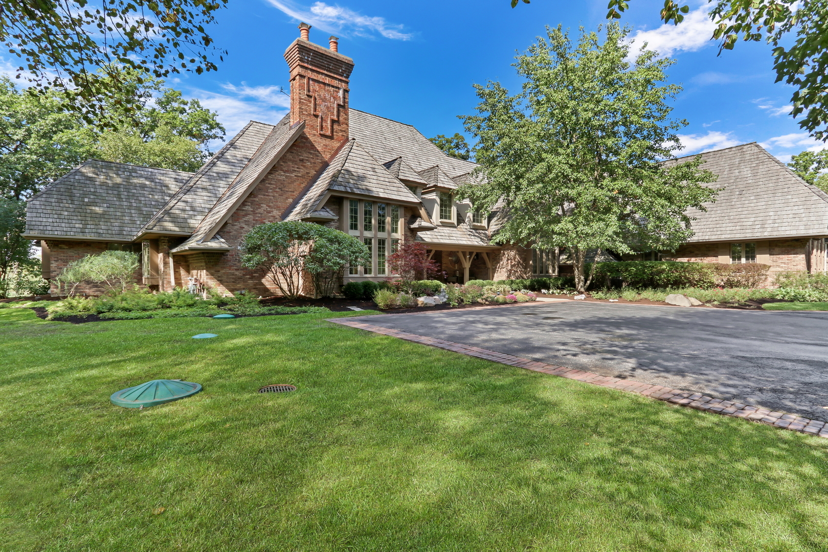 Nestled amid nearly 10 breathtaking acres along the Des Plaines River, this extraordinary all-brick estate is a rare opportunity to own a private retreat where timeless elegance, exceptional craftsmanship, and resort-style amenities come together in one remarkable property. Tucked away in a serene setting, this magnificent home offers an unparalleled sense of privacy while surrounding you with the beauty of nature and the peaceful presence of the river. From the moment you arrive, the impressive architecture, expansive grounds, and beautiful landscaping create an unforgettable first impression. Step inside and discover a home thoughtfully designed for both sophisticated entertaining and everyday living, with generously proportioned rooms, refined finishes, soaring ceilings, beautiful millwork, and an abundance of natural light. Recently refinished hardwood floors, new carpeting, fresh interior paint, new light fixtures, plantation shutters, elegant crown molding, and distinctive 8-foot hickory doors add to the home's warmth and timeless appeal. At the heart of the home is a stunning kitchen designed for both culinary enthusiasts and effortless entertaining. Featuring a Sub-Zero refrigerator, Wolf cooktop, Wolf double ovens, four-drawer dishwasher, granite countertops, custom cabinetry, and a custom-built pantry, this exceptional kitchen combines functionality with luxury. A charming beadboard ceiling adds architectural character, while the adjacent dining spaces provide the perfect setting for everything from intimate dinners to memorable gatherings. The dramatic family room is designed to impress, featuring a sunken floor plan, fireplace with a beautifully pavered surround, wet bar, and beverage refrigerator. A spectacular dining room with volume ceilings, a butler's pantry, and tiled built-in credenza provides an elegant backdrop for entertaining. The study showcases beautiful detailed molding, creating an inviting and sophisticated workspace. The home's private quarters are equally impressive. The luxurious primary suite offers custom-built closet cabinetry, dual closets, heated floors, and a dedicated makeup vanity, creating a serene retreat at the end of the day. Additional bedrooms are generously sized, including a beautiful Princess Suite with a walk-in closet and hickory flooring. Bedrooms two and three feature walk-in closets and share a convenient Jack-and-Jill bath. Upstairs, a tremendous bonus room above the garage offers incredible flexibility as a recreation room, media space, home office, fitness area, or additional living space. With five bedrooms including the bonus room and 4.5 bathrooms, there is room for everyone to spread out comfortably. One of the home's most extraordinary features is its spectacular indoor pool and spa retreat. The heated pool and jacuzzi are surrounded by an enclosed, temperature-controlled space featuring beautiful travertine floors, a cedar roof, and an enclosed veranda. A dedicated workout/viewing room overlooks the pool, providing a unique space for exercise, relaxation, or simply enjoying the stunning indoor oasis. The pool area is thoughtfully designed with accessibility in mind. Outside, the property truly comes alive. Nearly 10 acres of peaceful grounds stretch toward the Des Plaines River, creating an extraordinary backdrop for everyday life and entertaining. A maintenance-free deck provides the perfect place to enjoy morning coffee, summer gatherings, or quiet evenings overlooking the surrounding landscape. A dog run, new playset, flower-bed sprinkler system, and beautifully landscaped grounds add to the property's appeal. Adding another dimension to the property is the separate coach house, offering heated and cooled space with new flooring. Finished with beautiful bluestone details, it provides exceptional flexibility for guests, hobbies, a studio, office, receation space, or additional storage. A property of this scale, setting, and amenities is exceptionally rare.