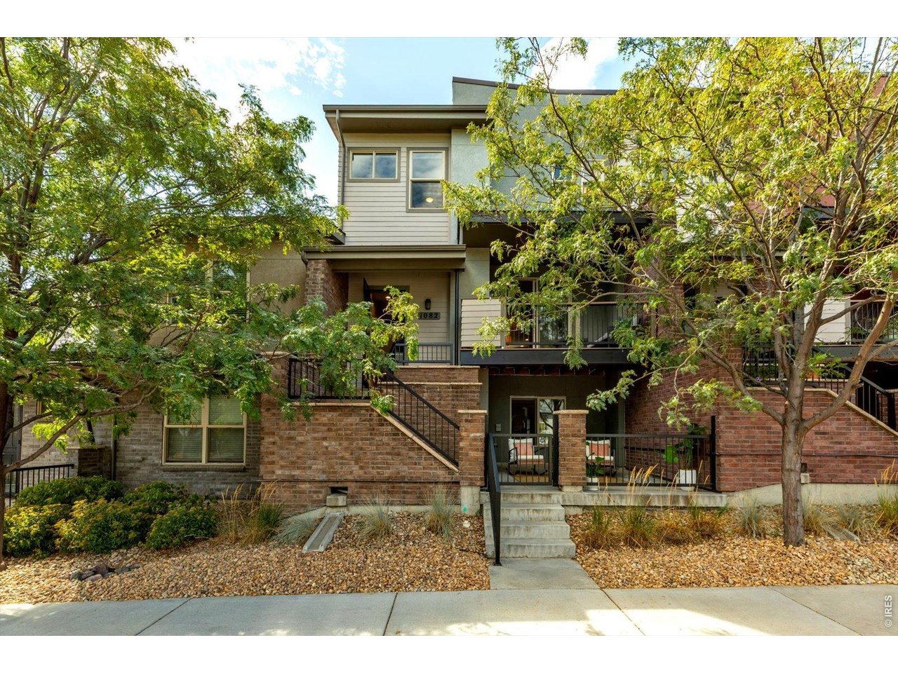 Enjoy the best of Old Town Louisville from this immaculate, one-owner townhome, offering a rare combination of walkability, privacy and low-maintenance living. Mature trees surround the home, creating peaceful, leafy views from the living room and primary suite, while the upper deck tucked beneath the tree canopy provides a surprisingly private place to relax. The open, sun-filled main level features wide-plank hardwood floors and an inviting living room with gas fireplace. The beautifully appointed kitchen includes quartz countertops, an extended center island with a breakfast bar, pantry, soft-close flat-panel hardwood cabinetry and KitchenAid stainless steel appliances with a gas range. Just off the kitchen, a cozy nook provides a comfortable second gathering space. Upstairs, the private primary suite features peaceful views, a 3/4 bath with double vanity and a walk-in closet. Two decks extend the living space outdoors, including a north-facing deck ideal for enjoying much of the year. A rare three-car garage provides abundant room for vehicles, bikes, outdoor gear, a workshop, or a home gym. The builder also offered an option to convert a portion of the garage into a fourth bedroom. Leave the car at home and enjoy everything that makes Old Town Louisville special. Stroll beneath the mature tree canopy to restaurants, coffee shops, the library, Farmers Market, Street Faire, parks and community events. Open-space walking and biking trails are just a block away, along with convenient access to the Boulder bus. Beautifully maintained and filled with natural light, this home offers the character and lifestyle of Old Town without the upkeep of an older single-family home, an ideal lock-and-leave home in one of Boulder County's most desirable locations.
