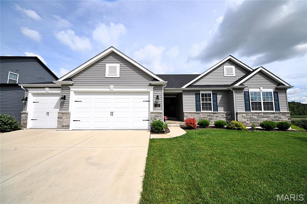 BETTER THAN NEW 3 years young Aurora model Lombardo custom built home FULL of upgrades on STUNNING wooded lot w/water view of lake/meadow. Exterior boasts large lot backing to trees w/covered cedar deck, custom drywalled and insulated oversized 3 car garage w/8 ft doors & 6 ft deep extension, stone/vinyl front & architectural shingle roof. Open floor plan interior displays 10 ft ceilings, luxury vinyl tile & TONS of natural light throughout main living area. Spacious great rm w/custom arch details leads to breakfast rm w/atrium door out to covered deck overlooking backyard views. Luxury kitchen includes 42" cabinets w/crown molding, center island w/breakfast bar, quartz counters, pantry & gas stove w/range hood. Separate mudroom & main fl laundry w/sink. Primary suite showcases tray ceiling, walk in closet & luxury bth w/walk in shower & oversized vanity. Two add'l bedrooms & full bath on main level. Partially finished walk out lower level includes possible in law suite w/HUGE bedroom, kitchenette/bar area w/breakfast bar & full bath w/walk in shower. Lower level also provides sprawling family room area w/sliders out to patio & backyard. More upgrades include: Solar panels (w/avg monthly electric lower than $15!), irrigation system, water softener, custom shelving in kitchen AND MORE! Why build when this comes with all the finishing touches a new construction won't! MUST SEE!