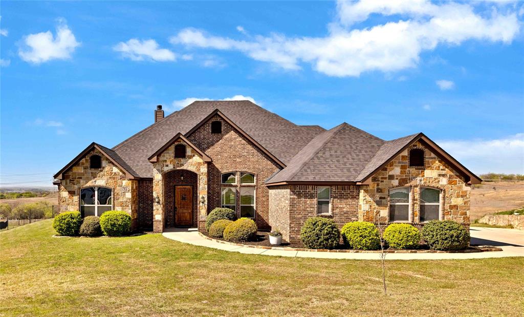 **ASSUMABLE VA LOAN for Veteran** Perched on a hilltop in the gated community of Lago Vista at Bonds Ranch, this beautiful one-story home offers the perfect blend of peaceful country living and modern convenience. Situated on over a full acre, the property boasts sweeping views, a sparkling pool, and an oversized covered patio—ideal for relaxing or entertaining. Inside, the open-concept layout is filled with natural light and anchored by a spacious living room featuring a cozy fireplace and stunning backyard views. The kitchen flows seamlessly into the living and dining areas and is well-appointed with granite countertops, a large island with breakfast bar, walk-in pantry, and built-in microwave. The thoughtfully designed split floor plan includes 4 bedrooms and 3 full bathrooms. The private primary suite offers a spa-like retreat with dual vanities, a soaking tub, separate shower, and a generous walk-in closet. The additional bedrooms are perfect for guests or multigenerational living—which share a full bath. The 3-car oversized garage and extended driveway provide ample space, including room for a boat. This home is loaded with upgrades and long-term value, including a TDI Impact Resistant Class 3 roof with transferable warranty, piered foundation and piered pool, spray foam insulation, and full Cat 5 wiring available to be set up for in-home sound and intercom system. Enjoy the best of both worlds—quiet, scenic living just minutes from Eagle Mountain Lake and the new Eagle Mountain High School, with easy access to major conveniences. Located just 25 minutes from downtown Fort Worth, 35 minutes from DFW Airport, and only 10 miles from Alliance Town Center with premier shopping, dining, and entertainment. Community amenities include gated access, fishing ponds, playgrounds, swimming pools, and walking trails. This is a rare opportunity to enjoy space, privacy, and high-end features—all within close proximity to the city.