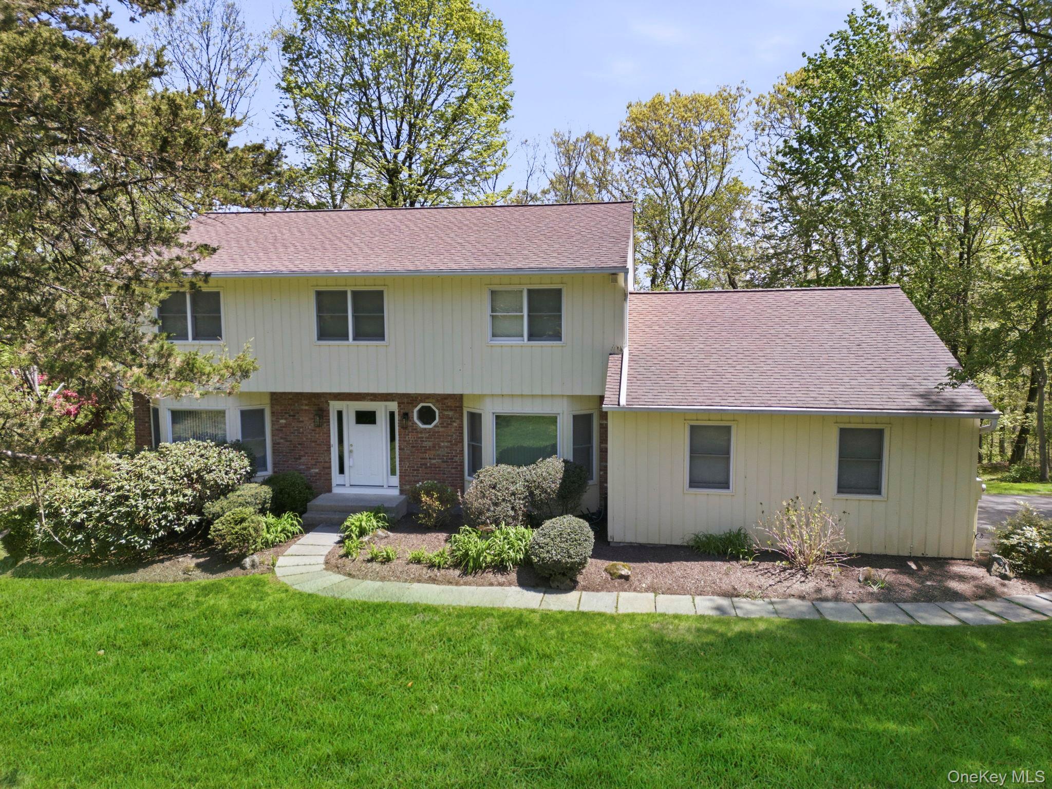Experience the perfect balance of classic charm and modern ease in this bright 4-bedroom, 3.5 bath perfectly maintained Center Hall Colonial on 1.3 acres. Located on a peaceful, low-traffic cul-de-sac street, this home stands out with its enviable low taxes and a layout designed for the way we live today. The traditional center hall entry gives way to a surprisingly open and airy floor plan, where rooms are bathed in natural light. The seamless flow leads you directly to the home's rear—a true retreat featuring a large, private deck that overlooks a peaceful, wooded backdrop. It is the ultimate setting for quiet morning coffee or hosting summer BBQs in complete privacy. The expansive walkout basement is 803 sq ft (included in total sq footage) a game-changer for flexible living. Bright and functional, it offers a home office space with a full bath, providing privacy and comfort for long-term visitors or a quiet, professional home office with its own separate entrance to the yard. Enjoy the best of Armonk living on a friendly neighborhood street where you can stroll the block with ease. Located in the award winning Byram Hills School District, you’re just minutes from town, yet once you step into your backyard, you’re in your own private sanctuary. Don’t miss this rare, move-in-ready Armonk value—schedule your tour today!