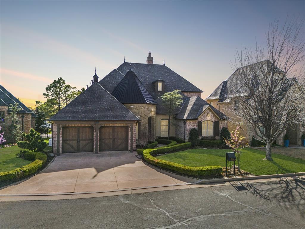 This exceptional home offers unobstructed lake views and a refined, low-maintenance lifestyle in Esperanza, gaterd community at 15613 Via Sierra. From the moment you enter, timeless craftsmanship and elegant design are immediately apparent. Hand-scraped wood flooring, Pella wood-encased windows and doors, crown molding, and soaring ceilings create an atmosphere of luxury throughout the home. The spacious living room is anchored by a striking cast-stone fireplace, and expansive windows, creating an inviting yet sophisticated space for everyday living and entertaining. The chef’s kitchen is both stunning and functional, featuring professional-grade Wolf, Sub-Zero appliances, double ovens, a large center island, and a breakfast bar, high-grade granite countertops, and abundant cabinetry. The dining room is perfect for hosting gatherings with family and friends. A well appointed executive study with custom built-ins, and is located off the entry. The luxurious primary suite offers a peaceful retreat with a spa-inspired bath complete with soaking tub, walk-in shower, and fabulous walk-in closet. A secondary bedroom with full bath is conveniently located on the main level. Upstairs, a spacious bonus room, an additional bedroom with private bath, and a walk-out balcony. The outdoor living space is just as impressive, featuring impeccable landscaping and a covered patio with serene lake views. The HOA maintains the yard, allowing for true lock-and-leave convenience. A whole-home backup generator included. Esperanza, one of Edmond’s premier gated communities, ideally located near top dining, shopping, and quick access to the Kilpatrick Turnpike. Residents of Esperanza also enjoy exclusive community amenities including a pool and clubhouse, enhancing the lifestyle this exceptional neighborhood provides. New Roof Coming! Welcome Home.