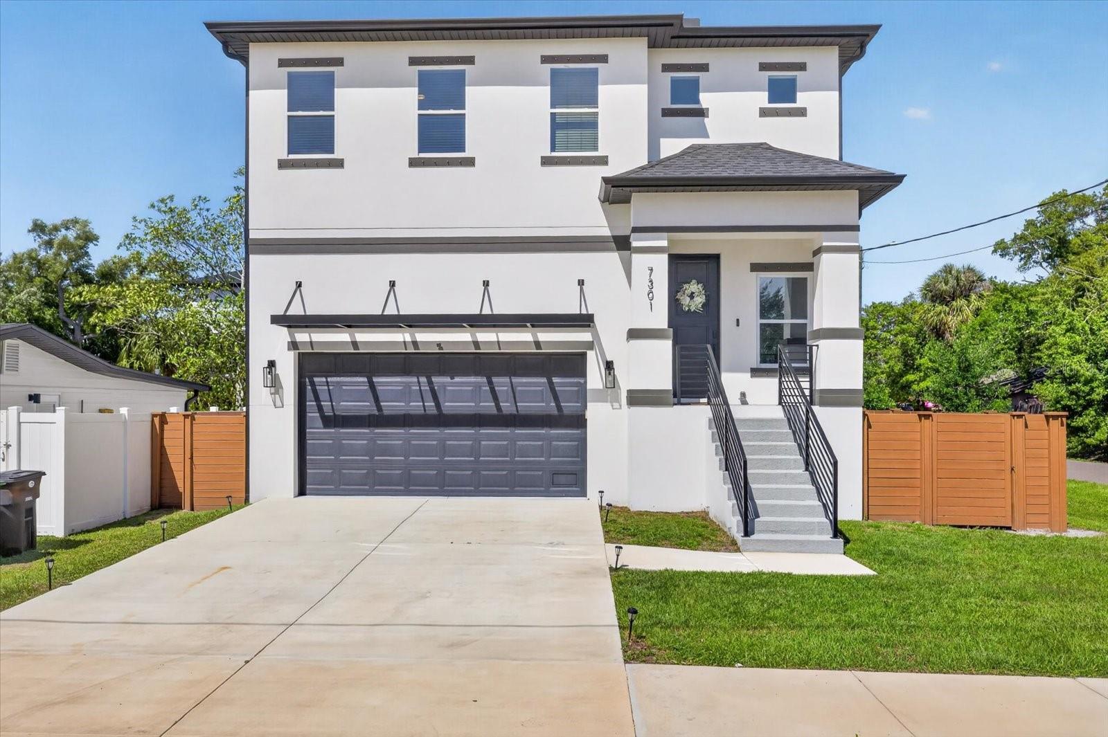 Welcome to this stunning modern residence in South Tampa where elevated design meets functional living. Built with both style and peace of mind, this home features raised construction and a clean contemporary exterior that immediately stands out.Step inside to a bright open concept living space with luxury vinyl plank flooring and an effortless flow between the living, dining, and kitchen areas. The chef’s kitchen is the centerpiece of the home, featuring a large quartz island with seating, sleek cabinetry, stainless steel appliances, and ample storage, perfect for entertaining or everyday living.The main living area opens to a spacious covered balcony, creating seamless indoor and outdoor living and an ideal space to relax or host guests year round.Upstairs, the primary suite creates a private retreat with generous proportions, a walk in closet, and a spa inspired bathroom complete with a freestanding soaking tub, glass enclosed shower, and dual vanities. Additional bedrooms are well sized and thoughtfully positioned, giving flexibility for guests, family, or a home office.The fully fenced backyard provides privacy and room to enjoy the outdoors, while the elevated design and newer construction add confidence and long term value. The oversized garage offers excellent functionality with high ceilings and built in overhead storage racks, providing plenty of space for organization while still comfortably accommodating parking.Conveniently located near dining, shopping, and everything South Tampa has to enjoy, this home combines modern design, a smart layout, and an unbeatable location.