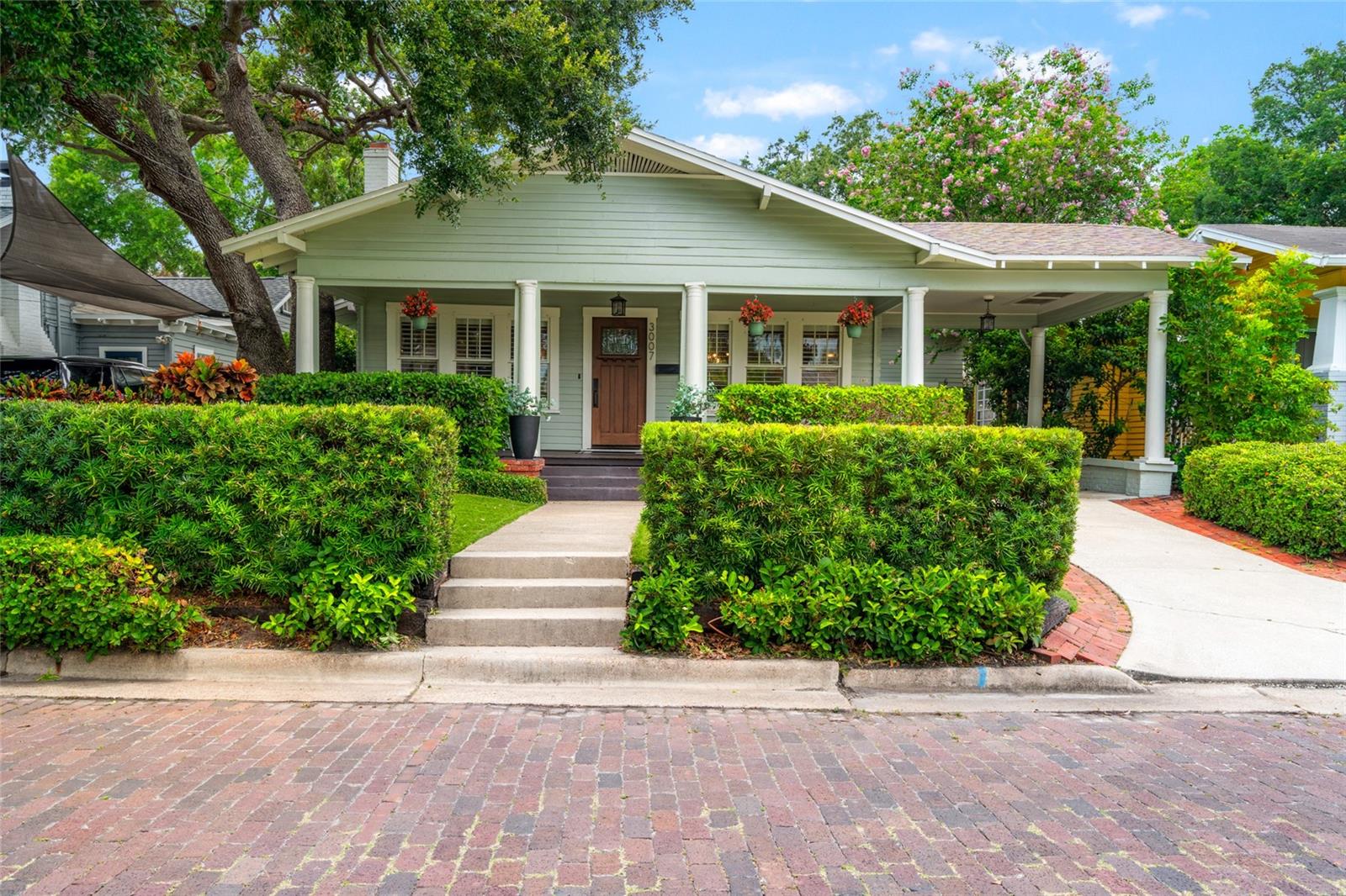 Nestled on a picturesque brick-lined street in the heart of coveted Palma Ceia, this beautifully maintained 4-bedroom, 2-bath bungalow seamlessly blends timeless charm with modern comfort. Keep your family safe in this HIGH & DRY, NO FLOOD ZONE residence. Featuring real wood flooring throughout, the home opens to spacious, sunlit living areas and an inviting layout perfect for both entertaining and everyday living. Step into a grand living room that gracefully opens into two inviting and intimate spaces. One corridor leads to two ground-floor bedrooms and a hall-access bathroom, offering comfort and convenience. The other corridor guides you into the formal dining room, where elegant wainscoting and upgraded lighting—complete with wall sconces and a statement chandelier—create a perfect setting for entertaining guests. From there, continue into the thoughtfully designed kitchen, featuring a breakfast bar and custom cabinetry ideal for displaying your finest stemware and china. But the true showstopper? A stunning set of triple glass doors that accordion open, seamlessly connecting the indoors to the pool area for effortless indoor-outdoor living.
Step outside to your private backyard retreat—complete with a sparkling pool (resurfaced 2017), relaxing hot tub (2017 Heater/2024 Filter/Pump), and a mosquito misting system for year-round enjoyment.

Ascend upstairs to a spacious primary retreat with a large walk-in closet and connected bathroom. Upstairs also offers the 4th bedroom - or can serve as an office or exercise room off of the primary suite. 
Just minutes from the Palma Ceia Golf & Country Club, Palma Ceia Park (playground, basketball & dog park) and scenic Bayshore Boulevard (fitness trail), this home places you in the center of South Tampa’s most desirable lifestyle. Enjoy close access to Hyde Park Village, local dining, boutique shopping, and nearby playgrounds.
