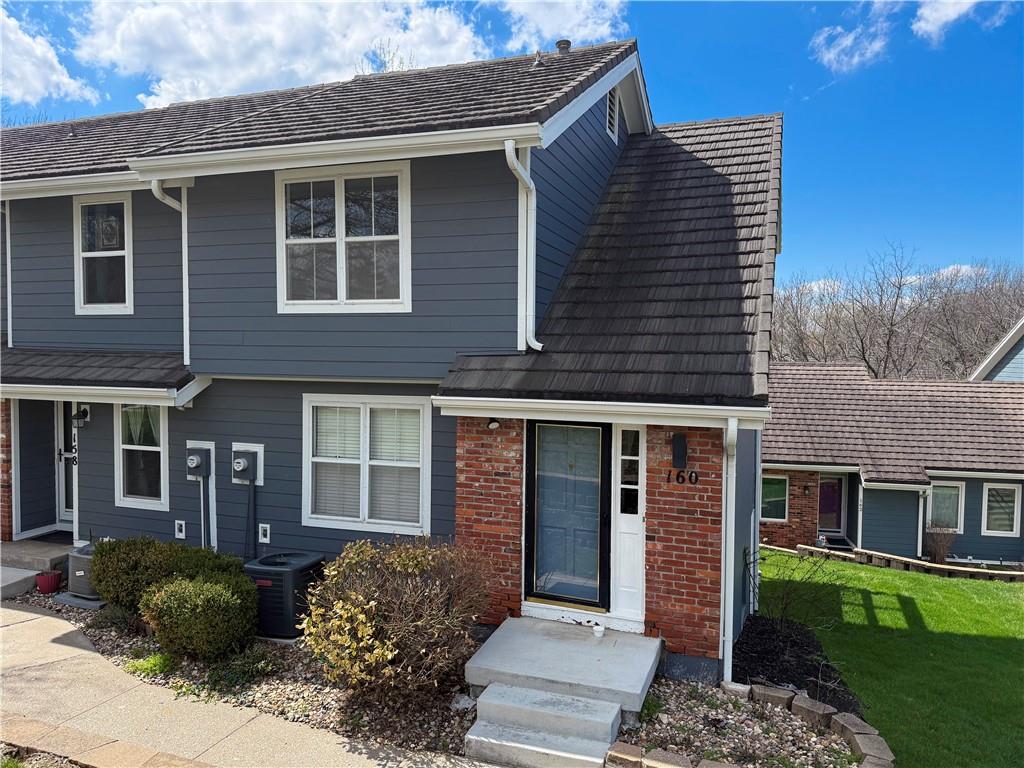 Welcome home to this beautifully maintained maintenance provided townhome in the highly desirable Lakewood community in Lee's Summit! This move in ready gem features an updated kitchen, a stunning beamed ceiling, and a cozy fireplace that anchors the inviting living room. A unique spiral staircase leads to the walk out basement, perfect for a spacious family room or easily utilized as a third bedroom with its closet area. The newly rebuilt deck was designed to add an additional level to the second story.  Enjoy the privacy of a quiet end unit, complete with two dedicated parking spaces.Recent updates include newer siding and roof, stylish lighting, modern ceiling fans, fresh paint, new carpet, updated flooring, and a well built newer deck, ideal for relaxing or entertaining. Located in Lakewood, you'll have access to incredible amenities including multiple pools, playgrounds, pickleball courts, the lake, and even golf course access. This is low maintenance living at its best with a lifestyle to match!