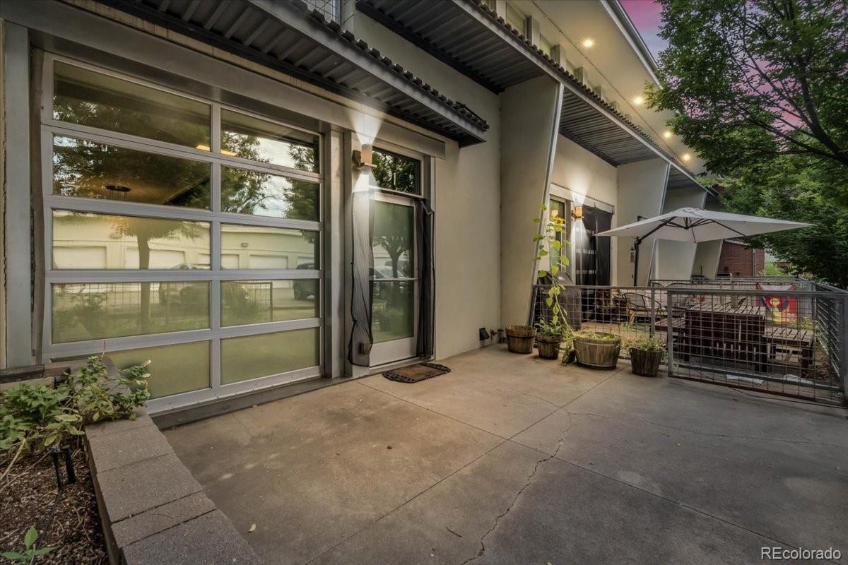 Modern, loft-style Montclair condo lives like a townhome! Full of character, this 2 bedroom, 2 bath unit end unit has no units above or below. Historic details throughout, with a few industrial touches from this building’s inception as a 1950s frozen food factory. You’ll love the concrete floors downstairs, open kitchen/living space with a roll-up garage door that expands your living space to the outside and to your large, fenced private patio. In unit laundry! Kitchen has newer appliances (2022),  granite countertops, and cooks will love the induction oven. The entire second floor is the primary bed/bath with a generous private second story deck. Comes with exclusive use of a large 1-car garage (w/lots of storage room) and another dedicated off-street parking spot. Less than a 5 min drive to King Soopers and Safeway grocery stores as well as the outstanding French bakery/restaurant La Fillette, walkable to Fiction Brewing Company, less than 10 minutes to Stanley Marketplace and a short hop to I-70 gets you to fun, food, or to points beyond in reasonable time!