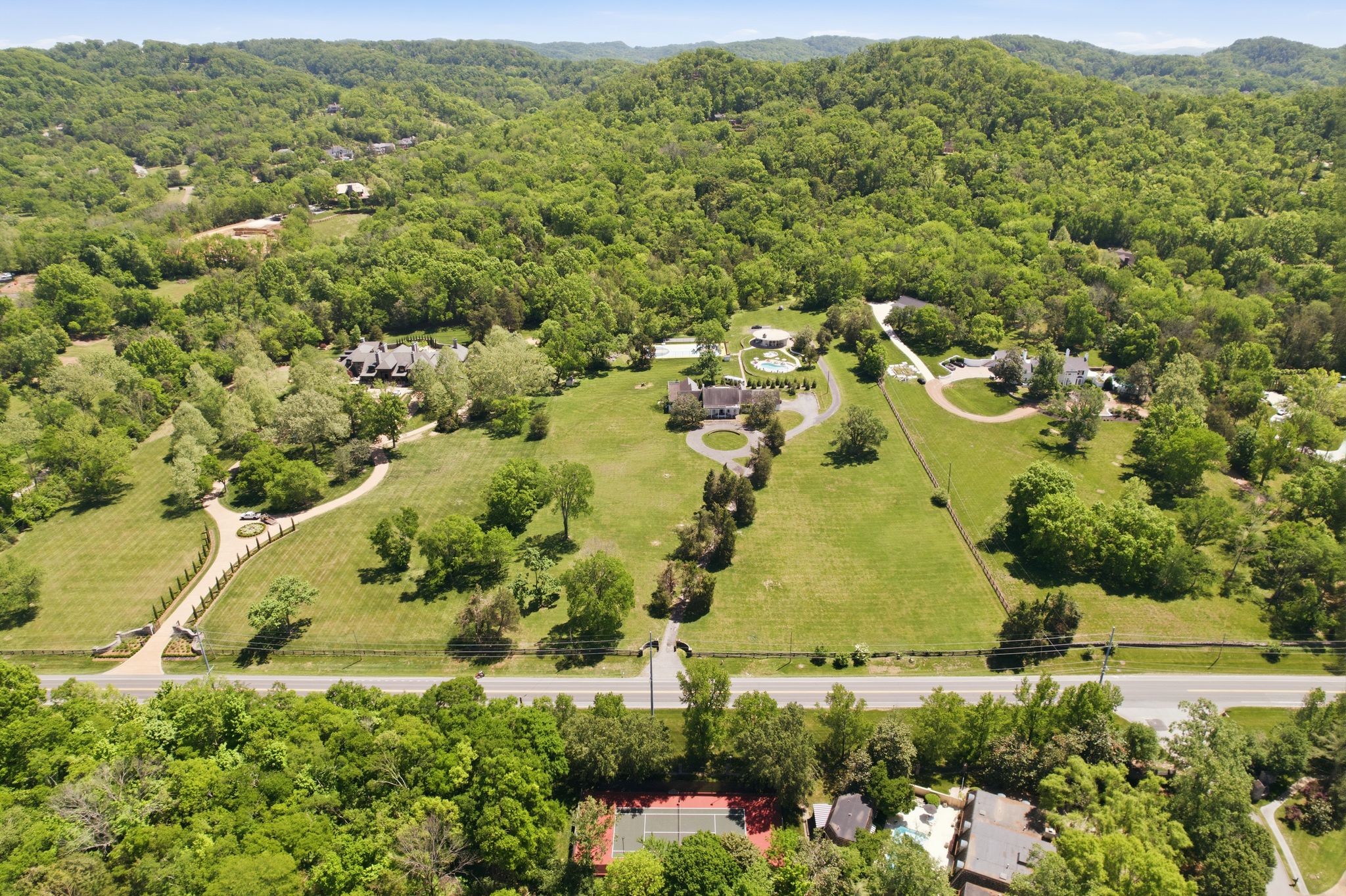 See Link to Website for full property details.  https://www.hillsboropikeluxuryliving.com.  Located in the heart of Forest Hills along Hillsboro Pike, this 21.45 - acre property offers one of the largest private estate opportunities currently available in Nashville. Preliminary concept drawings by architecturally trained designer Ray Booth of the acclaimed McALPINE firm are available as a source of inspiration. Buyers also have the opportunity to engage Ray Booth and the McALPINE team to help design and realize their dream home.Set behind mature hardwoods and an expansive rolling lawn, the land provides exceptional privacy while maintaining convenient access to Green Hills, Brentwood and downtown Nashville. THE EXISTING RESIDENCE IS A TEAR DOWN, creating a true blank canvas for a custom luxury estate. Several high-value improvements remain, making this property uniquely positioned for immediate vision and development. Limited Service Listing-Buyer and/or buyer's agent to verify all information.