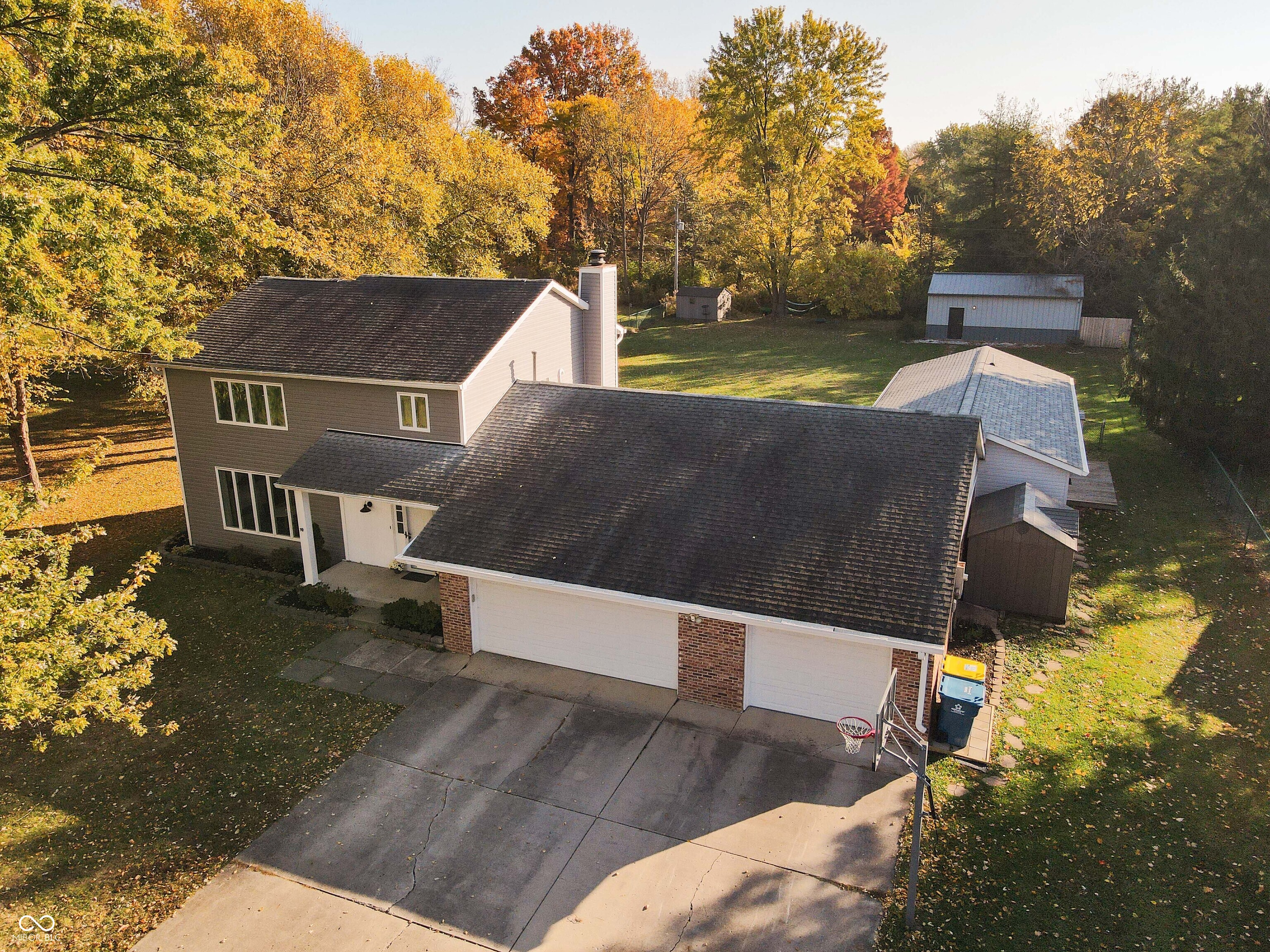 Discover a truly unique property off of 106th in Fishers with no HOA and packed with features you won't find anywhere else. Situated on a spacious, fully fenced lot, this home includes an enormous 3-car garage and exceptional versatility throughout. In 2019, a full in-laws quarters was added with two private-entries, offering a large living area, full kitchen with all appliances included, spacious bedroom and bathroom making it perfect for multigenerational living, guest space, or rental potential. Also added in 2019 is a fully finished outbuilding (18X30) with heating and cooling that can function as a home office, recording studio, creative workspace, gym, or more. The possibilities are endless. Brand new carpet and fresh paint throughout the home!   Awesome fenced backyard which is great for entertainment.    Don't miss your chance to own this one-of-a-kind Fishers property!