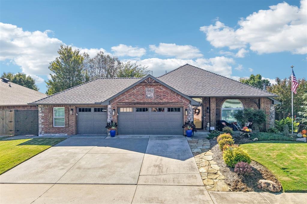 Some homes you tour. This one you experience — starting at the curb. Perched on an oversized corner lot in Park Place, this brick-and-stone beauty pairs manicured curb appeal and a timber-accented covered front porch with a backyard built for staying home. Inside, rich wood floors, vaulted ceilings and exposed wood beams set the tone. The main living room is anchored by a corner gas fireplace with a soothing green surround and chunky wood mantel, and flows openly into the formal dining room and kitchen — while a second, oversized family room with a reclaimed-wood accent wall gives you a game room, media room or home gym all its own. The kitchen delivers: glazed concrete countertops, a contrasting breakfast bar with seating, rich wood cabinetry with glass fronts, mosaic tile backsplash, stainless appliances and a gas range, plus a full pantry and French doors opening to the patio. A rustic sliding barn door reveals one of this home's favorite surprises — a laundry room with a built-in tiled dog wash. The primary suite is a true retreat with a walk-in closet and a beautifully updated spa bath: double vanities, marble-look tile, a soaking tub set beneath a picture window and a large glass-enclosed shower. Two more bedrooms share an updated Jack-and-Jill bath with double vanities, and a powder bath serves guests. Outside, the living space just keeps going — a covered back patio with hot tub, a pergola-shaded side patio with stamped concrete and a curved stone seating wall, an above-ground pool wrapped in a wood deck, raised garden beds, a large storage shed and a fully fenced, lush green yard made bigger by the corner lot. Add owned rooftop SOLAR-PAID OFF in full, so the savings start day one, a tankless HWT, an oversized 3-car garage (approx 36' x 22') with an in-garage walk-in storm shelter, and Norman schools, and a seller-prepaid home warranty through July 2028 for peace of mind long after closing  — and this is the one they'll be talking about. Welcome Home!
