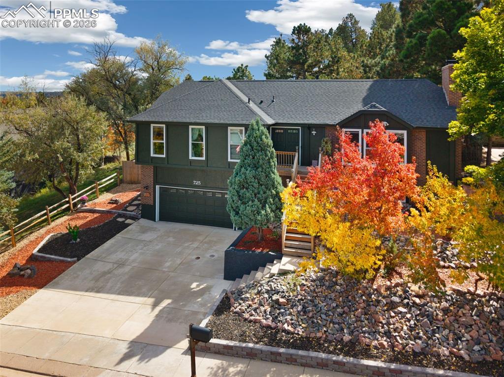 BEAUTIFUL UPDATES!! And remodeling in this raised ranch home that backs to Rockrimmon Open Space. Beautiful zeroscaping with huge wrap around rear deck accented by pine trees and scrub oak. Luxury Vinyl floors and designer paint greet you into this vaulted open house. Gorgeous granite kitchen with gourmet gas stove, Stainless Steel appliances, instant hot water faucet and pullout cabinets. Dining room with built-in Custom bar with beverage refrigerator included. Bright open sunroom walks out of kitchen area and through to the deck and Mountain Views. All tiled baths plus a master suite with full wall of closers. Enjoy the wood brick fireplace in the lower family room with TV included. Brand New Roof, Gutters, exterior paint and driveway, extended oversized 2 car garage, 50 gallon water heater New garage door opener and tons of garage storage shelving. District 20 Schools and easy access to Air Force Academy and I-25.