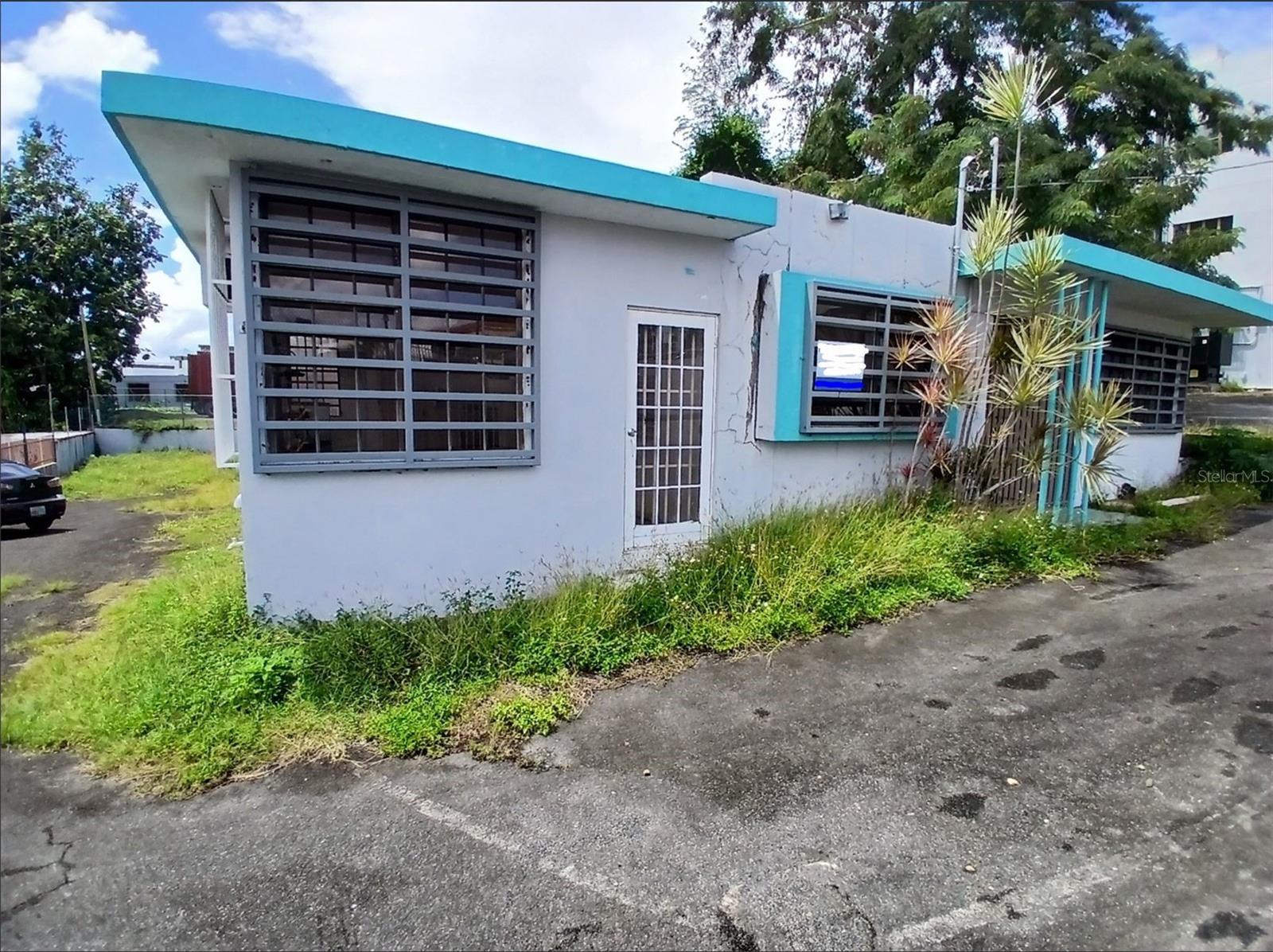 This property is a 3 bedroom (currently 3 offices) 2 bathroom single story 1800 square foot house on a 688 square meter lot just off route 2 on the Guaynabo-Bayamon Puerto Rico border. Approximately 75% of the property including the house are located in Guaynabo. The remainder of the property is in Bayamon. In the past the house has been used as professional offices so has the flexibility of either continuing as a commercial property or can be converted back to residential use. The house does need repairs and upgrades to a Buyer's desires. The location of the property makes the property very flexible for either residential or commercial use as the property is in a location with high commercial activity along with many amenities and activities for residential living.Entering the house one comes to the large entrance foyer/reception area. To the back right of the entrance foyer is the dining room. To the right of the entrance foyer is office #1 which could easily be converted to a bedroom. To the left of the entrance foyer are two more offices which could also be converted to bedrooms. At the back of the building past the entrance foyer is the kitchen, utility room and the two bathrooms. The building could be utilized to continue it's current office use, be converted to residential use or be utilized as a combination residential/office property.The Guaynabo/Bayamon area where the house is located is one of the premier areas of Puerto Rico. Nestled in the heart of the San Juan metropolitan area, the area offers a rare blend of upscale suburban comfort, strategic location, and vibrant Puerto Rican culture. Known for a high quality of life, top-rated bilingual schools, and secure neighborhoods, the Guaynabo/Bayamon area is one of the most sought-after residential and investment destinations on the island of Puerto Rico. The area boasts first-class amenities including luxury shopping centers like San Patricio Plaza and Galería Suchville, gourmet restaurants, boutique fitness studios, and exclusive country clubs such as Hyde Park and the prestigious Bayamón Golf Club. The area is also home to numerous health and wellness centers, including state-of-the-art hospitals and private clinics. All these amenities are less than 15 minutes from the property with Galeria Suchville being just 500 feet from the property.The area also blends modern living with cultural richness. Historic sites like Caparra Ruins, vibrant arts scenes, and local festivals give Guaynabo-Bayamon a unique character. The area features abundant green space with parks, trails, and outdoor areas ideal for recreation and relaxation.In addition to all that Guaynabo, Bayamon and the San Juan Metropolitan areas have to offer there are also many attractions all around the Island of Puerto Rico. These attractions include, but are not limited to, over 300 beaches around the Island, El Yunque Rain Forest, Scenic mountain lake areas, Bio luminescent bays, Guanica Dry Forest, Zip line adventure parks, Cave exploring, West Coast Surfing competitions, Off island trips to Culebra and Vieques, and many other activities.All in all the property is an excellent flexible use property located in an area conducive to both business activity and a vibrant enjoyable lifestyle.