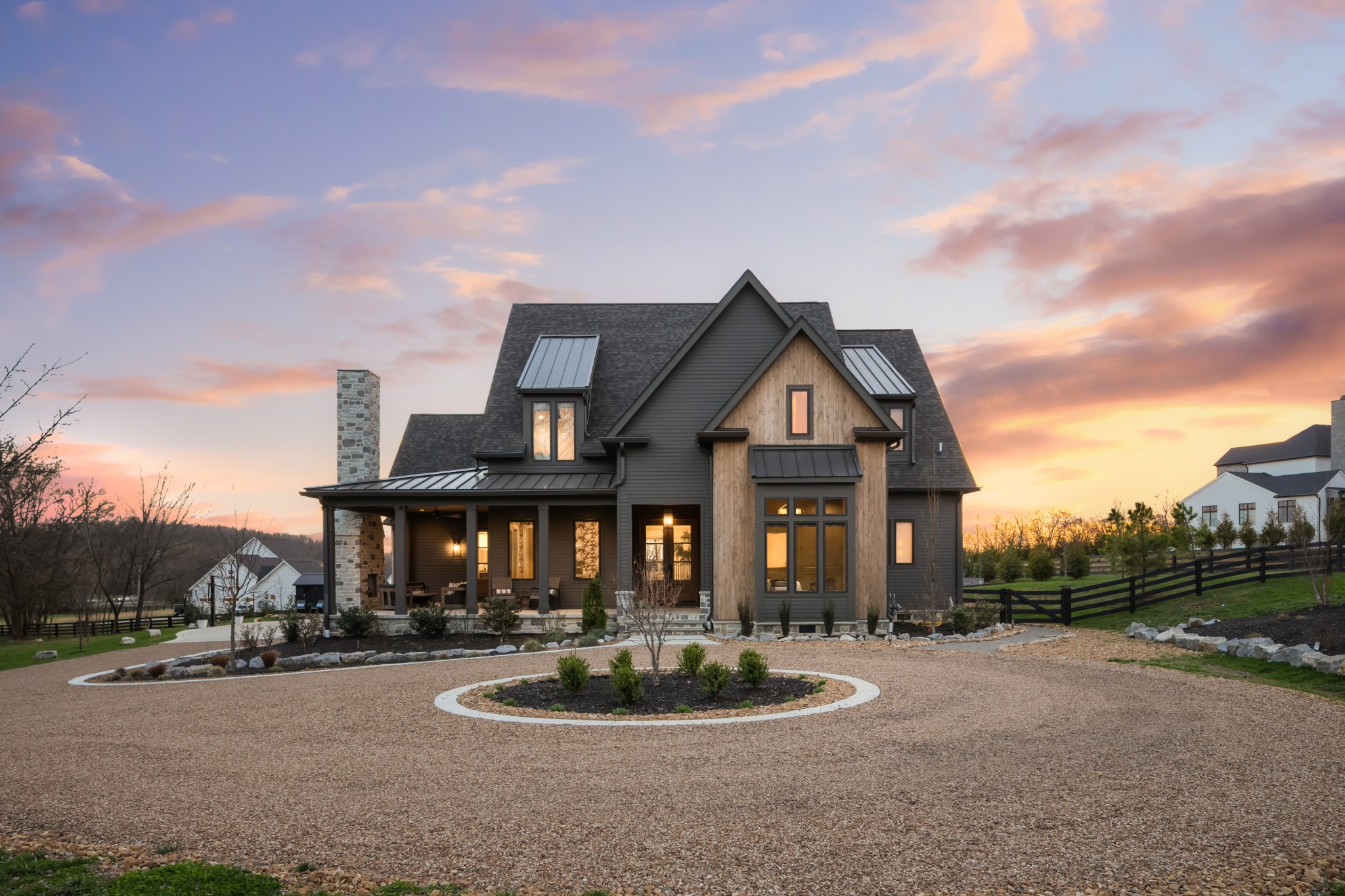 Tucked behind a tree lined drive on more than five beautiful acres in one of Franklin’s most coveted locations, this newly built custom home built by Jamie Ferguson offers a rare blend of refined luxury, privacy, and timeless Tennessee living.Completed in 2024, the home spans 5,841 square feet and features five bedrooms, five full baths, and one half bath, along with a private suite above the garage with its own full bath, ideal as a guest retreat, office, bonus space, or in law suite.Inside, exceptional craftsmanship and carefully curated design define every space. Hardwood floors run throughout the home, complemented by designer lighting, custom finishes, and striking wallpaper selections that bring warmth and character. The kitchen is outfitted with premium Fisher & Paykel appliances and anchored by stunning natural stone, creating a space that is both beautiful and highly functional for everyday living and entertaining.Outdoor living is equally impressive. A welcoming front porch and expansive back porch, both with fireplaces, invite year round enjoyment. The screened porch features a built in grilling area, while the backyard centers around a resort style gunite pool and spa overlooking peaceful acreage and unforgettable sunset views.Set well back from the road behind a line of mature trees, the property offers a sense of privacy that is increasingly rare this close to town. The pea gravel drive leads to open green space where life unfolds naturally, children running through the field, a rope swing hanging from a favorite tree, afternoons spent gardening, and long evenings gathered by the pool.Wrapped in beautiful stone and cedar siding, this home captures the very best of Tennessee living, peaceful, private, and picturesque, yet just five minutes from Franklin’s renowned shops, restaurants, and everyday conveniences.