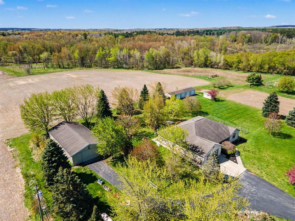 This beautifully designed, 3,200 finished square foot home offers a wonderful blend of comfort, space, and superior quality featuring solid oak flooring, solid doors and custom oak trim, on almost 31 acres in Central Michigan. 3 spacious bedrooms and 3.5 bathrooms, the layout is thoughtfully designed for both everyday living and entertaining. The heart of the home is the open-concept main living area, where the kitchen, dining, and living spaces flow together with ease. Large windows bring in an abundance of natural light and create a bright, welcoming feel throughout. The kitchen offers ample counter space, quality cabinetry. A beautiful family room provides a great spot to relax while taking in views of the property. The primary suite serves as a private retreat with its own en-suite bathroom and generous walk-in closet space, while the additional bedrooms are well-sized and conveniently situated for family or guests. The finished lower level adds even more flexibility, offering excellent space for recreation, hobbies, entertaining, or extended living arrangements with the same comfortable finish carried throughout the home. Outside, the property truly stands out. In addition to the attached garage, there is an impressive Turn-Key 30' x 60' x 12' pole barn featuring a finished ceiling with 15" of blown in fiberglass insulation and 3-inches closed cell spray foam insulation on the walls, an 80,000 btu propane heater making it, a great workshop, ideal for storage, recreational vehicles, or equipment. There is also an additional 4-bay with concrete floor storage garage, perfect for additional storage. With a mix of open ground, multiple types of fruit trees, pear, peach and wooded acreage, and 2400 of the Pine River along the property, this is a rare opportunity to enjoy privacy, walking trails usable land, and a beautifully maintained home all in one setting. Internet is Tri-County fiberoptic.
