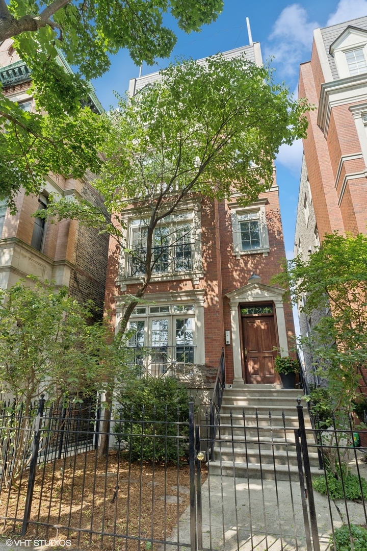 This stunning Lincoln Park 3-bedroom and 3-bath residence features classic, dignified Georgian architecture with timeless curb appeal all in a coveted location. Nestled among multi-million dollar homes and just minutes from the city's top schools, this residence offers a truly unique living experience. The elegant flavor presented throughout this gorgeous home is rarely available in this price range. Your wishlist has come true, including a spacious and sun-drenched first floor venue with large floor to ceiling windows that perfectly frame the tree-lined neighborhood views, a grand lower level with separate bedroom and full bath that would serve as a perfect live-in nanny residence, a stylishly updated kitchen with quartz countertops, hardwood floors throughout, impressive trim work, garage parking with plentiful space for strollers, spacious private deck, and multiple enormous closets and storage areas throughout. Sip your morning coffee in the elegant living area looking out at your beautiful neighborhood while you enjoy the bells of St. Michael's in the distance. Enjoy an elegant cocktail hour with friends and family on your large private deck, then meander indoors for dinner in one of many perfect dining venues.  Just a short walk from Chicago's historic Gold Coast, Lake Michigan, and some of the city's most sought-after restaurants, this urban home is a rare find.