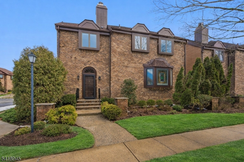 This beautifully maintained 3-bedroom, 2.5-bath detached townhouse offers the privacy of a single-family home with no common walls, set within a well-kept condominium community with low HOA fees. The main level welcomes you with a tiled entry foyer leading to spacious living and dining rooms with engineered oak flooring and elegant crown molding. The eat-in kitchen features granite countertops, undercounter LED lighting, stainless steel appliances, and a Pella sliding door with integrated blinds opening to a large TimberTech deck. A cozy family room with wood burning fireplace and an additional sliding door provides access to a charming covered patio, ideal for outdoor entertaining. A stylish powder room with marble countertop completes the first floor. Upstairs, the primary suite offers multiple closets, including a walk-in, along with a spa-like bath featuring skylights, a soaking tub, separate shower, and granite vanity. Two additional bedrooms, a full bath, and a convenient laundry area complete the second level. The lower level includes a two-car garage with epoxy flooring and a dedicated storage room. It also features a partially finished basement with a workshop, additional storage space, a French drain, and a sump pump. Ideally located just one mile from the train station, this home offers excellent natural light, attractive landscaping, and numerous recent updates, including exterior painting (2024) and a new roof, skylights, and chimney cap (2021).1 mile to train.