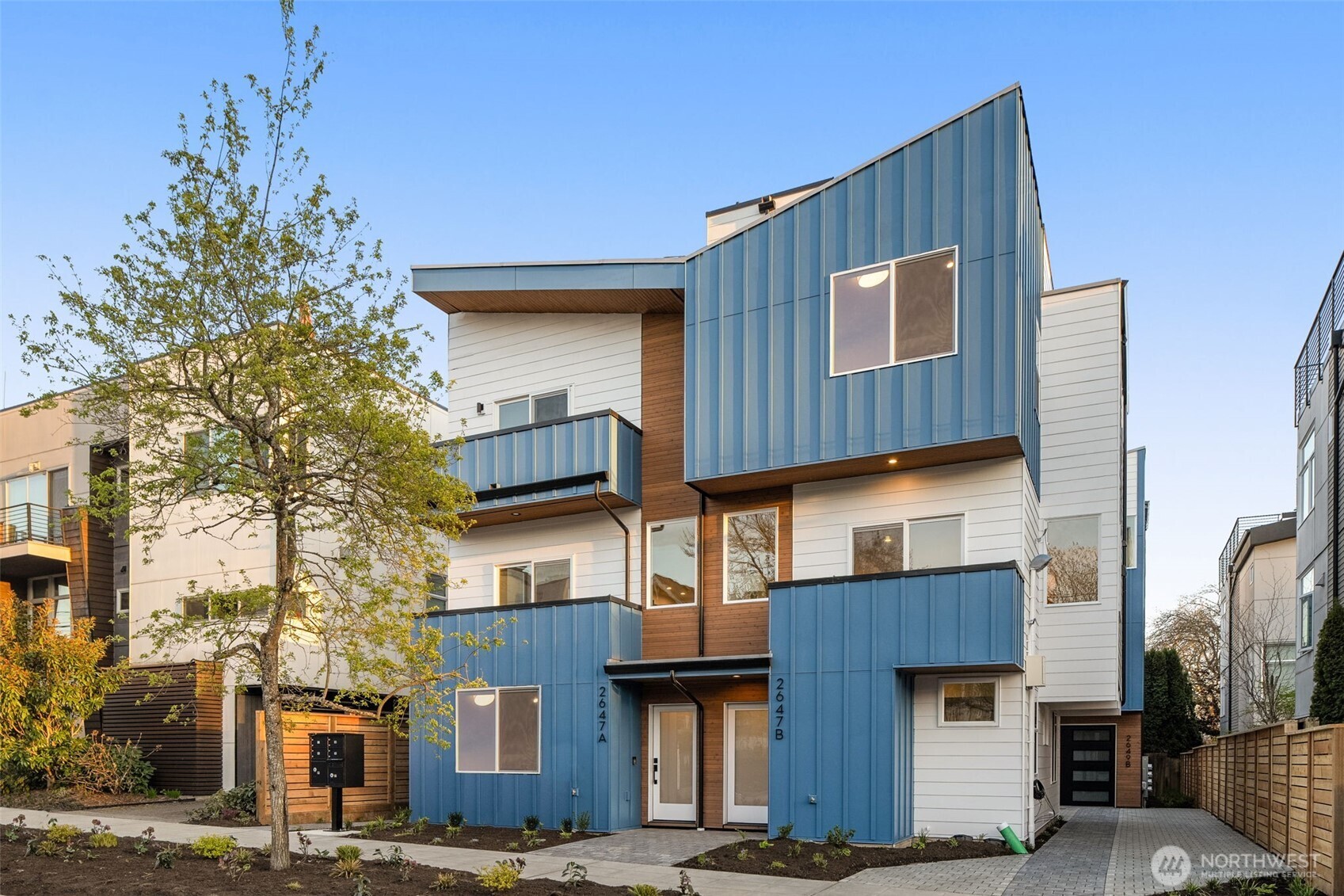 Final Home available at this extremely popular Ballard collection, and once you're here, it's easy to see why!    Enjoy unbeatable proximity to Ballard Avenue, Market Street, Golden Gardens, and Salmon Bay Park, with easy access to local restaurants, breweries, and the farmers market—putting the best of Ballard right outside your door.    The entry level is open and inviting, with seamless flow between kitchen, dining, and living spaces. A deck space adds outdoor relaxation, while the designer kitchen features quartz countertops, sleek cabinetry, stainless steel appliances, and a generous island for gathering.    The upper level provides two bedrooms and a full bath, ideal for guests, a home office, or flexible living arrangements. Clean architectural lines, large windows, and contemporary finishes create a bright, welcoming introduction.    On the top floor, the primary suite offers a true retreat with a spacious bedroom, walk-in closet, and spa-inspired bath. Above it all, a private rooftop deck delivers sun-soaked living space—perfect for entertaining with views stretching all the way to downtown. There's nothing like life in Ballard!