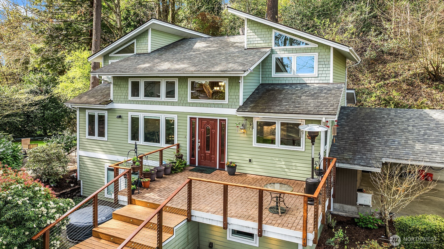 PRICE REDUCED + $25,000 CREDIT TO BUYER! Apply it toward a rate buydown, price reduction, or future updates. Set among majestic maple & fir trees, this beautifully remodeled home is a serene retreat in nature. Enjoy views of the lake & Mt Rainier, & a private 800-foot trail system. Nearly an acre of greenspace, a haven for wildlife. Spacious yard accommodates play structures, view deck, & patios. Triple-pane Pella windows, cherry cabinetry, quartz countertops, & hardwood accents enhance home’s elegance. The main floor features a family room, chef's kitchen, dining area & office. Upstairs is the primary suite & bath plus two more bedrooms. Lower level has one bedroom, office, kitchenette, bath & laundry. Ideal for an MIL with own entrance.