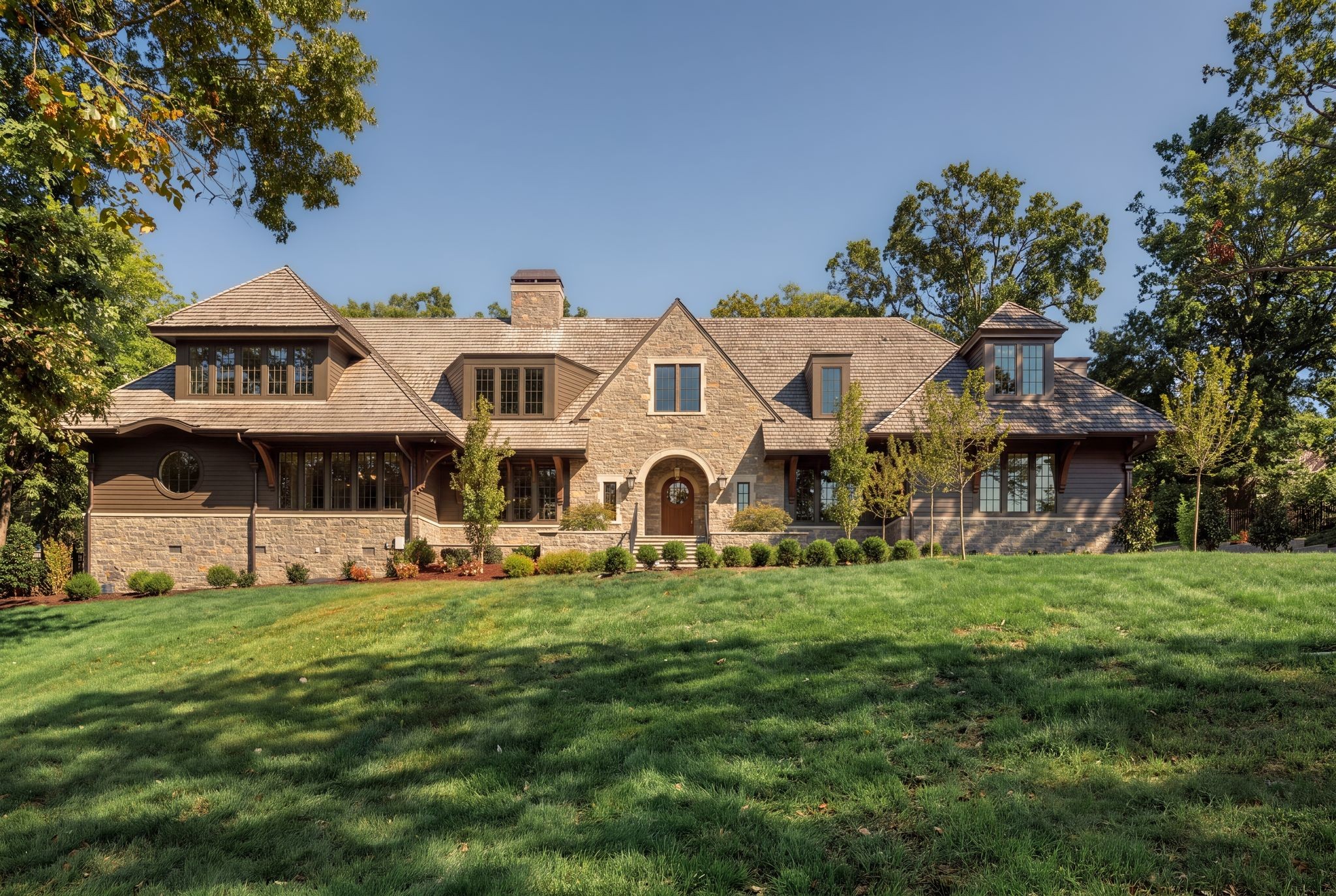 Introducing 606 Westview, The New Heirloom. Set on 1.21 acres along one of the neighborhood’s most admired streets, this English Arts & Crafts-inspired residence pairs timeless architecture with an extraordinary level of craftsmanship and design detail. Real stone, wood lap siding, and a cedar shake roof create an enduring first impression, while the custom pool and beautifully planned landscaping by Gavin Duke elevate the property into a true private estate.Designed by R Higgins Interiors, the inside of the home is designed for refined everyday living and entertaining, with an emphasis on timeless quality, proportion, and warmth spread over an excellently designed floor plan of 7,562 square feet, with 5 beds, 6 full and 2 half baths.On the main floor, you are welcomed into a warm, paneled foyer with a formal dining and wine cellar to the right and a grand vaulted living and entertaining area with adjacent kitchen, scullery, laundry and boot room, and sunny breakfast room to the rear of the home. As you enter the more private wing of the main floor to the left, you'll find a cozy den/media room with fireplace, a secondary bedroom suite, and a vaulted master bedroom with adjacent sitting area that opens to the pool area. Upstairs features 3 more bedroom suites, a bonus room, game room, craft and secondary laundry room, and multiple flex/storage rooms. Both floors are serviced by an elevator, and each floor has a powder room. The pool features its own separate pool bath with outdoor access.The result is a truly singular opportunity: a new Belle Meade home with architectural pedigree, exceptional grounds, and a level of finish that speaks to legacy rather than trend. It stands as one of the area’s most compelling offerings for the buyer seeking permanence, privacy, and distinction.