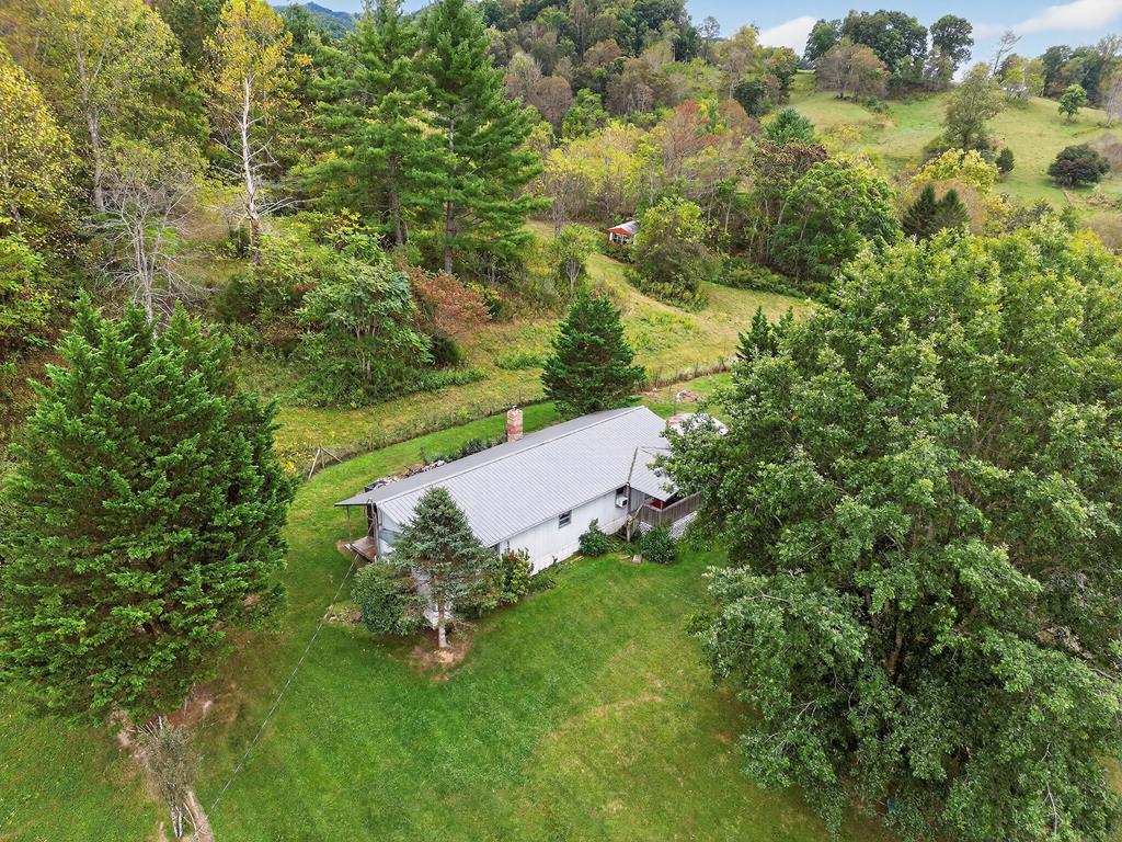 Financing is available!  Set on 11 beautiful acres featuring a pond, a small creek, and a mix of woods and open cleared land, this property offers the perfect combination of privacy and country charm. The spacious manufactured home provides approximately 1,600 square feet of living space, including 3 bedrooms and 2 full bathrooms. Inside, you'll find a large kitchen with plenty of cabinet and countertop space, ideal for cooking and gathering. The comfortable living area includes wood flooring and a wood stove for cozy nights, complemented by a new electric furnace installed in 2021 and a gas heater for supplemental warmth.  Relax on the covered front porch while taking in the peaceful surroundings and views of your own private acreage. With public water, road frontage, and a metal roof less than 10 years old, this property combines practical updates with serene, natural beauty.  Whether you're looking for a country getaway, small farm, or full-time residence, this Virginia property delivers space, comfort, and the tranquility of rural living at its finest.  Property is two single-wide mobile homes together, not a doublewide.  See your agent to discuss financing options.