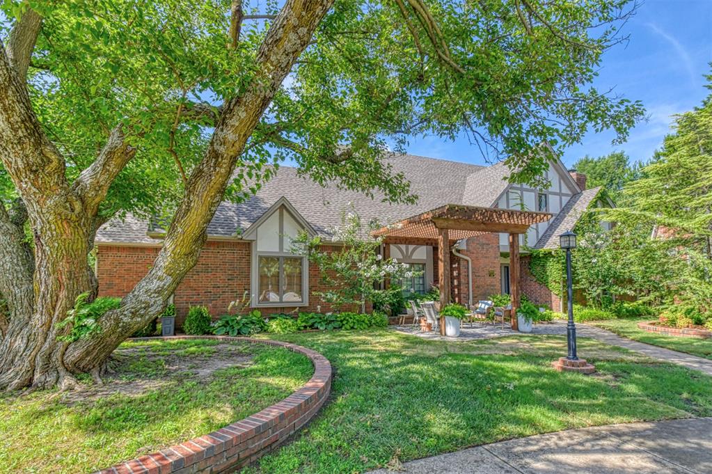 NEW PRICE! Perfectly positioned on a beautifully landscaped corner lot in a quiet cul-de-sac just steps away from beloved Brookhaven Park, this exceptional Old English/Tudor-style residence artfully blends timeless architectural character with refined modern updates in one of Brookhaven’s most coveted settings ~ Built in 1986 and offering 2,915 square feet, the home features three generously sized bedrooms, 2 1/2 bathrooms, and a private office with double French doors. Rich with personality, you’ll find thoughtfully designed built-ins throughout, a grand staircase, formal dining room, abundant natural light, and beautiful site-finished white oak floors downstairs complemented by wood shutters ~ The spacious kitchen is designed for both function and entertaining with double ovens—including a convection oven—an island gas cooktop, extensive countertop space, and a new dishwasher ~ Upstairs offers bamboo flooring and upgraded carpet, while the luxurious primary bedroom suite features a hidden passage behind the bookshelves, a fully renovated bathroom which includes separate his-and-hers vanity, a gorgeous stand-alone garden tub, a stunning tiled walk-in shower all with gold hardware and updated lighting ~ Additional highlights include roomy under the stairs storage, dual HVAC units with the upstairs system replaced in 2024, a 12–14 person garage floor storm shelter, underground sprinkler system, extra garage storage, and unbeatable convenience with easy access to I-35, restaurants, shopping, and entertainment ~ WELCOME HOME!!!