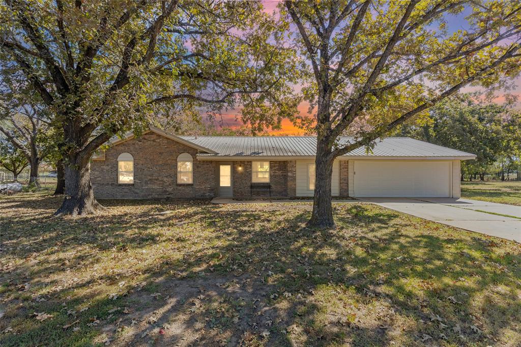 TOTALLY UPDATED and ready to move in!  Check out this 3 bedroom 2 bath brick home on over one acre with beautiful Oak shade trees. This home has been recently updated with new flooring, wiring, sheet rock, doors, windows, paint, lighting, bathroom fixtures, appliances, water heater, shelving and much more. The open concept in this home allows for additional room and show cases a totally updated kitchen with new quartz counters, island with new gas stove, oven and eating area. The new  custom built heavy duty cabinets with pullouts for easy access and organization. All new flooring, sheetrock, doors and paint throughout the house providing for the new house look with recessed lighting to boot! New windows have been installed for extra energy efficiency and savings. The metal roof and brick exterior provides added durability and less maintance on the outside. This home also has an extra large garage that could possibly be enclosed into a large family type room or additional bedrooms if needed. New concrete covered patio was also added for an entertainment place in the shaded backyard. The extra shaded lot on the south allows for enough space for a shop or to possibly even add a second home! Located just off I30 with easy access for a quick trip to Greenville, Sulphur Springs or DFW.