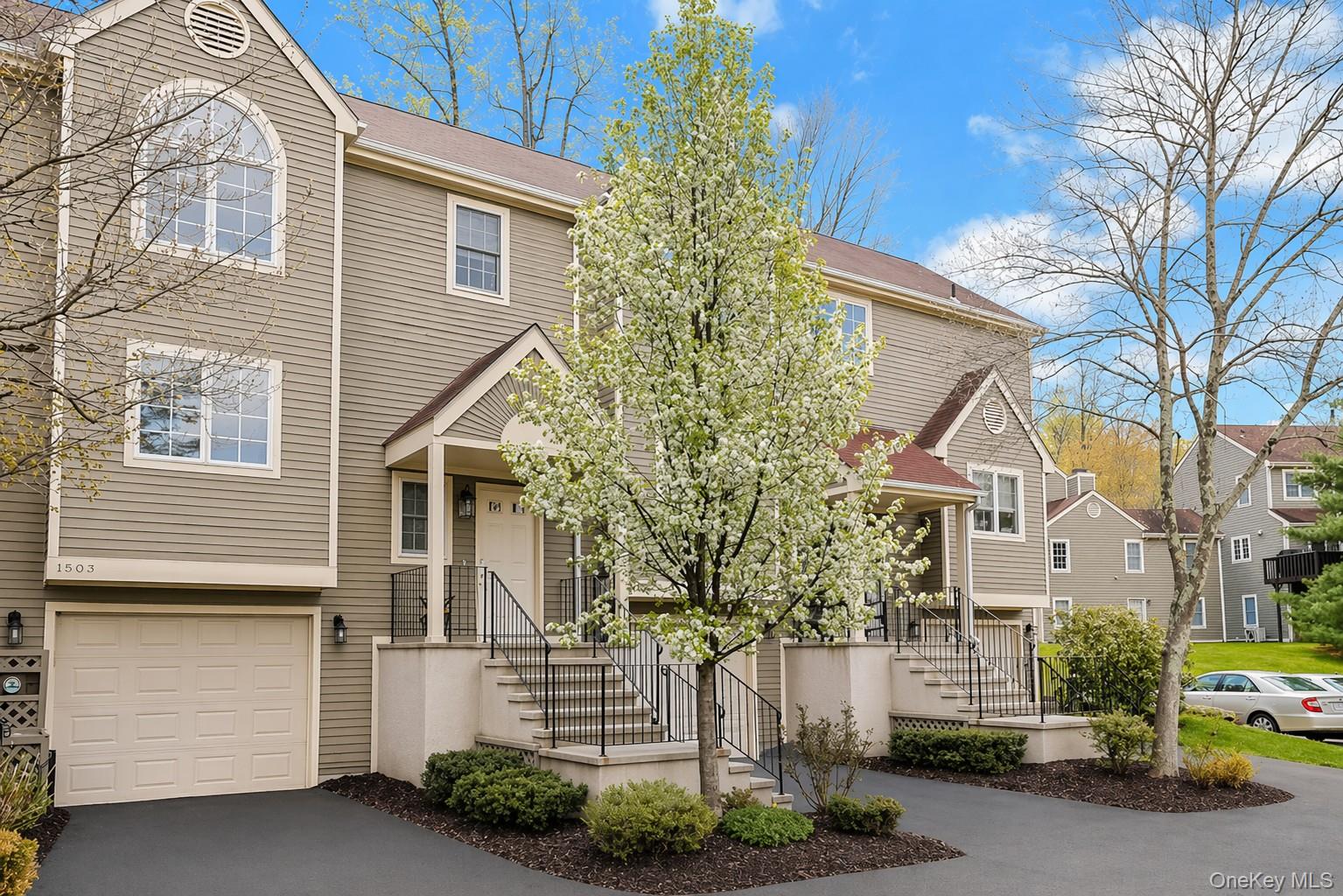 Welcome to this beautifully updated townhome in the highly desirable Guard Hill Manor community. Offering 2 bedrooms and 2.5 baths, this home features a bright, functional layout perfect for today’s lifestyle.The main level showcases an open, updated kitchen with granite countertops and stainless steel appliances, flowing seamlessly into the dining area and inviting living room with a wood-burning fireplace. Sliding doors lead to a private stone patio and backyard—ideal for relaxing or entertaining. Hardwood floors run throughout.Upstairs, the spacious primary suite offers a walk-in closet and newly renovated en-suite bath. A second bedroom also features its own newly renovated en-suite bath, along with a convenient washer/dryer.The finished lower level provides approximately 300 sq ft of additional living space (not included in total square footage), perfect for a family room, home office, or den, with direct access to the garage, mechanicals, and storage.Recent updates include new heating and A/C, three renovated bathrooms, appliances, and more.Enjoy Guard Hill Manor amenities including an inground pool, tennis and basketball courts, playground, and guest parking right outside your door. Ideally located just minutes to shopping, dining, and the Mount Kisco train for an easy Manhattan commute.