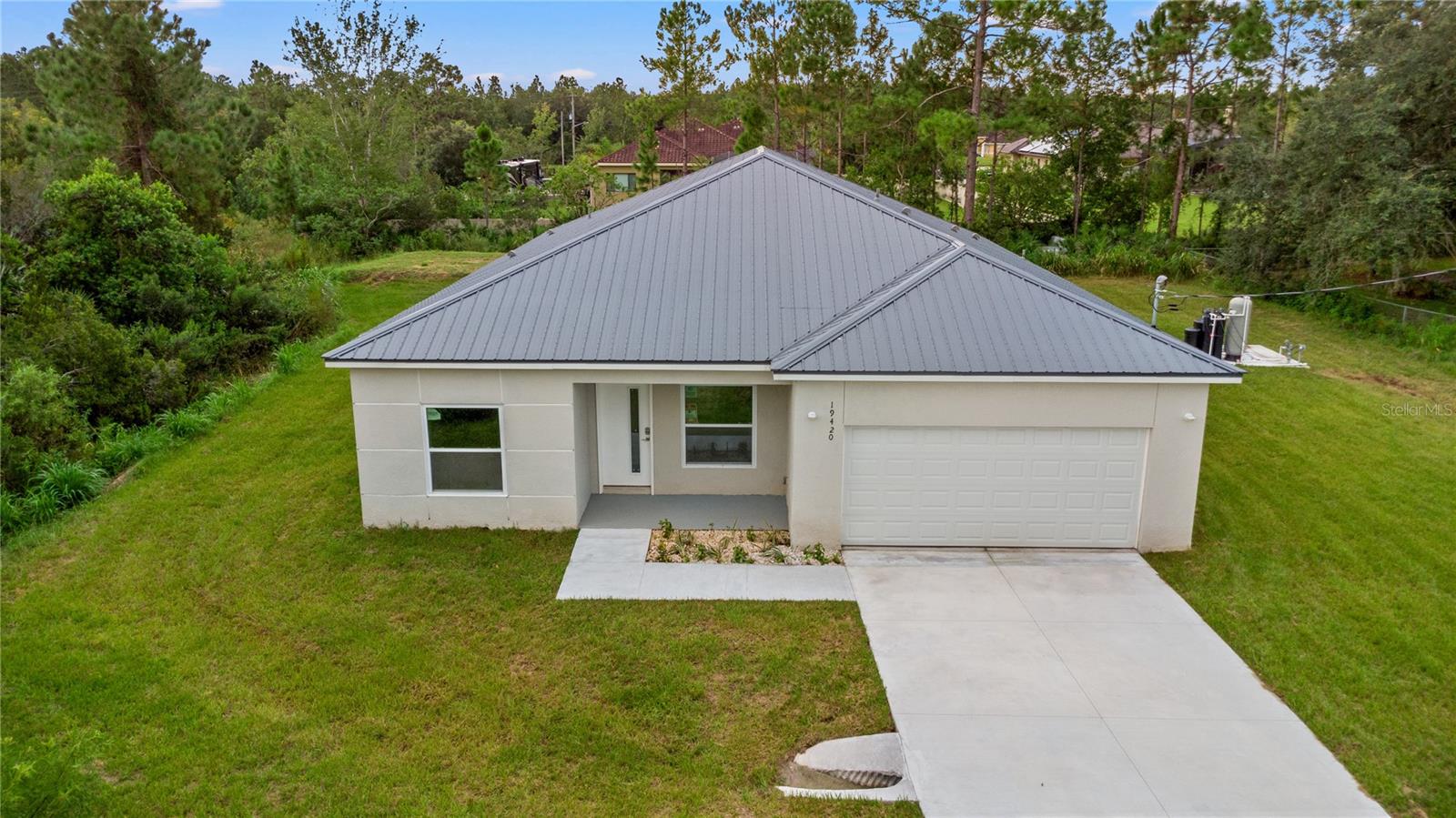 Welcome to this custom-built steel framed home, set on just over 1 acre in the desirable Wedgefield community. Surrounded by trees and natural greenery, this private retreat offers a peaceful lifestyle while still being just 25 minutes from downtown Orlando, 18 minutes from the airport, and 35 minutes from the beaches.
This spacious 5-bedroom, 3-bathroom home features an open split floor plan with soaring 9’ ceilings and vinyl flooring throughout. The kitchen is the heart of the home, complete with custom European-style cabinetry, stainless steel appliances, a large island with quartz countertops, seating, and a stunning waterfall edge design.
The master suite offers dual walk-in closets, a spa-like bathroom with a freestanding tub, separate shower, and dual sinks. A private mini suite with its own entrance provides the perfect setup for in-law quarters or guests.
Additional highlights include a zoned mini split A/C system, deep well with water treatment system, covered front entry, and a 2-car garage. With plenty of space for animals or simply enjoying nature.
Don’t miss the chance to own a unique home offering both privacy and convenience—schedule your showing today!