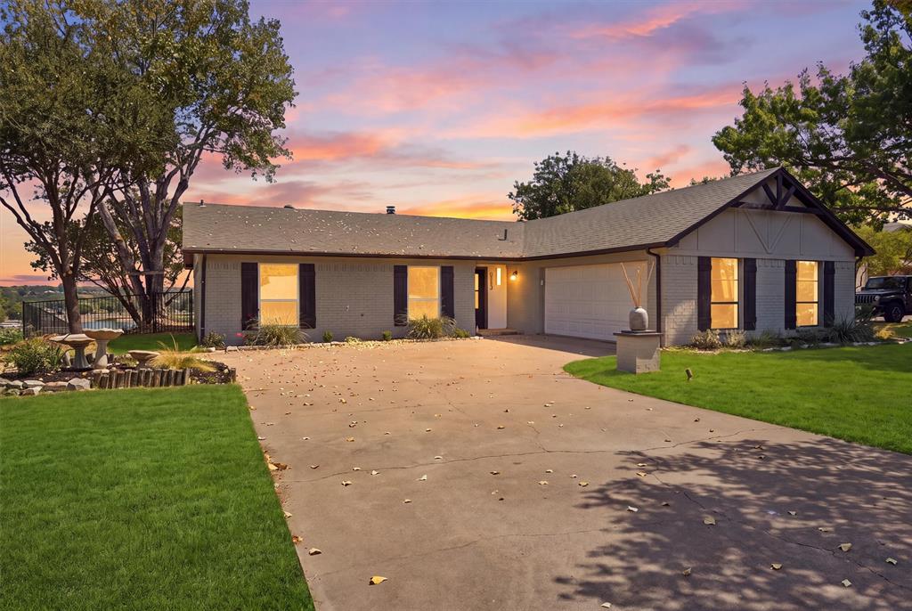 Waterfront living in DeCordova Bend Estates with the views, updates, and lifestyle buyers are looking for! This beautifully updated 3 bedroom, 2.5 bathroom home offers two spacious living areas, a dedicated office, wet bar, 2 car garage, and modern finishes and fixtures throughout. The bright white kitchen features an abundance of cabinetry, expansive counter space, and bar seating, opening easily into the main living spaces. But the showstopper is the wall of windows framing incredible water views with the golf course and sand volleyball courts visible across the lake. Imagine starting your morning here with the water as your backdrop or ending the day watching the view change from your own living room. The second living area and wet bar create even more room for entertaining, while the dedicated office is conveniently located near the half bath. Outside, the property continues all the way to the water with a private boat dock, putting lake days right in your backyard. Located inside gated DeCordova Bend Estates, residents enjoy access to golf, swimming, pickleball, tennis, a marina, clubhouse, dining, and more. With waterfront property in DeCordova always in demand, this newly updated home offers an exceptional opportunity to enjoy the lake, the community, and the amenities at a value that is hard to overlook.