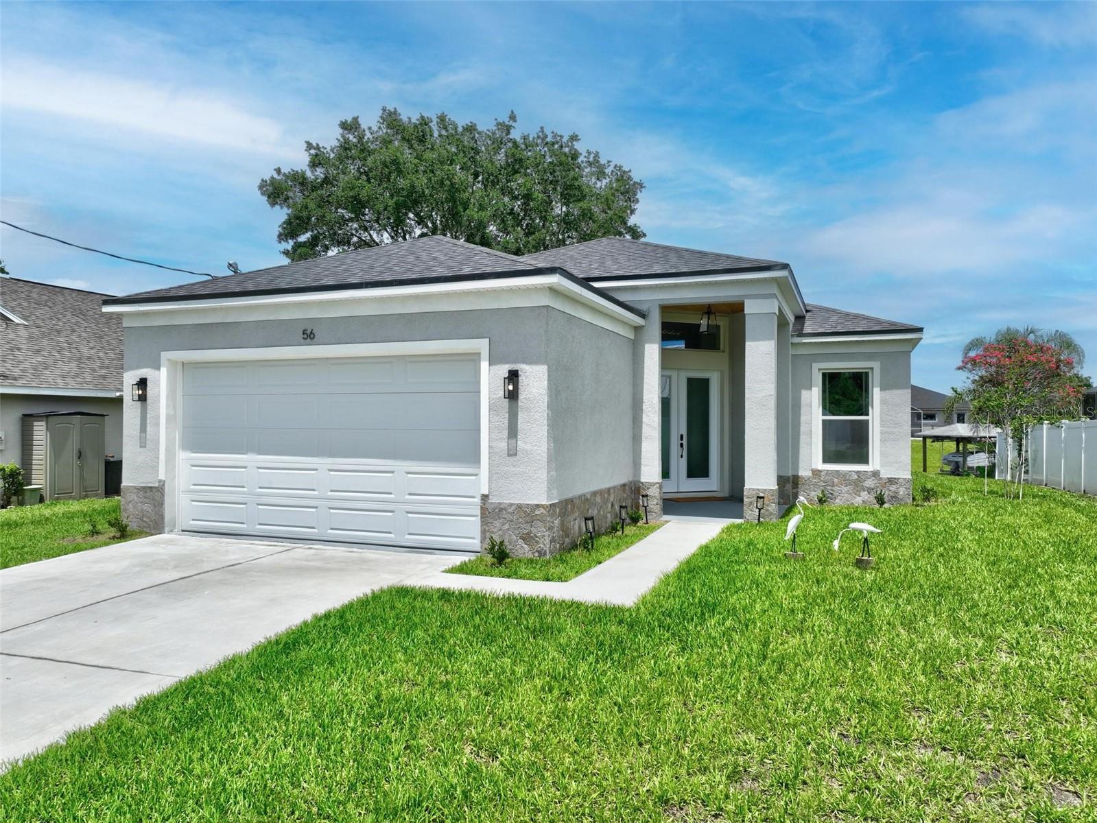 Experience the pinnacle of coastal elegance in this stunning home, perfectly situated on a scenic saltwater canal. This 3-bedroom, 2-bathroom residence offers east-facing water views from the enclosed lanai—ideal for peaceful mornings and serene evenings. Step inside to a beautifully designed open floor plan, featuring a designer kitchen with an oversized island, ample cabinetry, and premium finishes throughout. Luxury wide plank vinyl flooring in a warm oak tone enhances the home's elegant appeal. The primary suite is a true sanctuary, showcasing tranquil water views and a spa-inspired bathroom complete with a freestanding soaking tub, wet room shower, and double-sink marble vanity. Additional highlights include generous closet space, a spacious laundry room, soaring 12-foot ceilings, and a wide, welcoming entry hallway that leads to a striking accent wall in the living room. Don’t miss this rare opportunity to own a thoughtfully crafted home that seamlessly blends comfort, style, and waterfront tranquility. Located 15 minutes to Atlantic Ocean, 30 minutes south of St. Augustine, 30 minutes north of Daytona Beach, 1 hour from Jacksonville and 90 minutes to Walt Disney World.