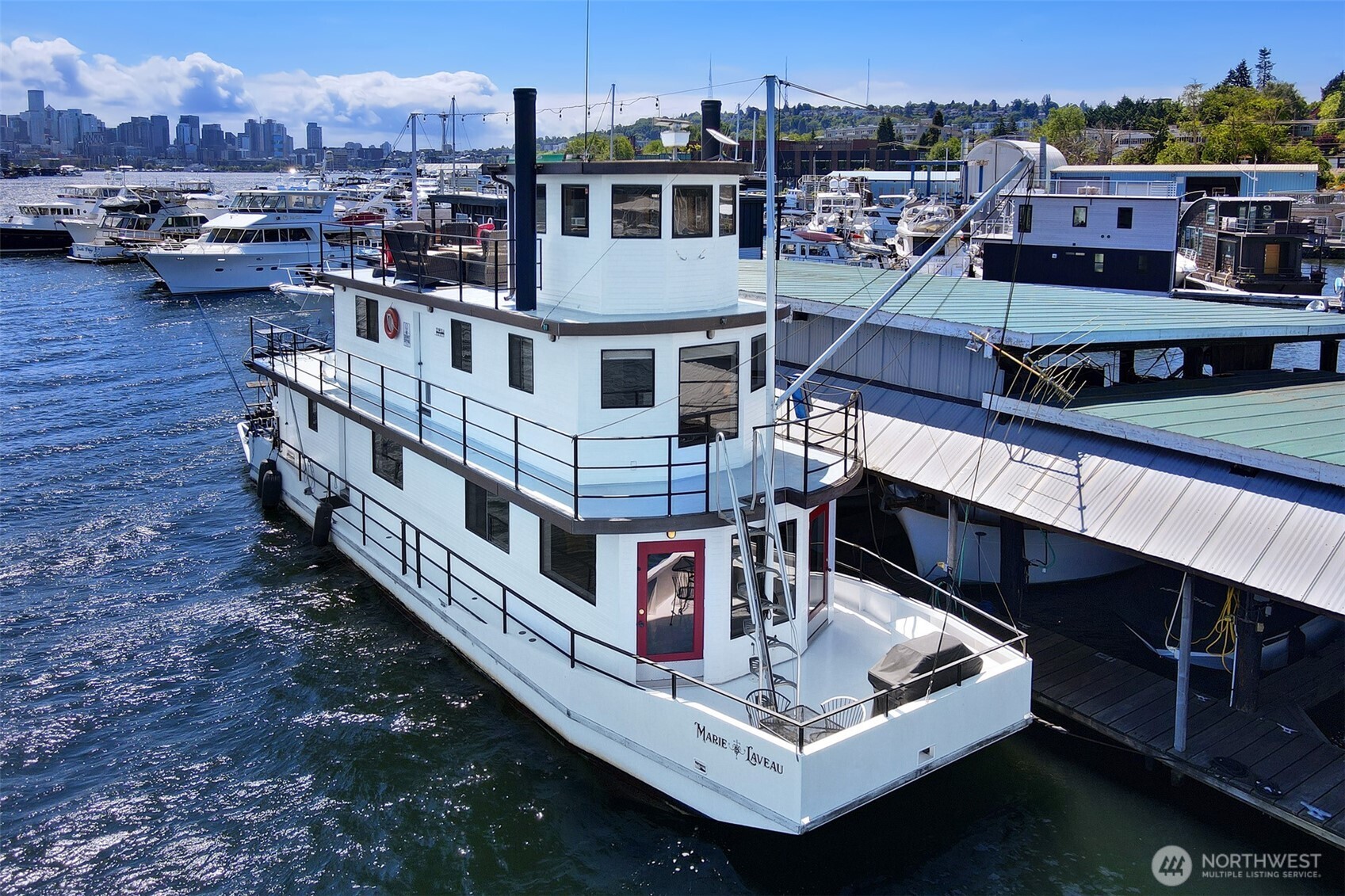Marie Laveau, legendary New Orleans’ priestess, was known for her stunning appearance, profound healing abilities, and enduring cultural impact. Like her namesake, this beautiful houseboat is truly one-of-a-kind. With 3 stories atop a steel hull, the Marie Laveau features nearly 1,300 sq ft of living space, 1.5 baths, large decks, and expansive lake and city views. Stunning kitchen with Verona gas range and double ovens, luxurious bath w/ custom shower and heated tile floor, and primary bedroom featuring built-in cabinets and an unobstructed view of Lake Union. Hardwood teak flooring, new carpet, updated marine wiring, 110 AMPs, 3 cargo-holds w/ massive storage, FOWR placard, no real estate taxes, parking permit and more.