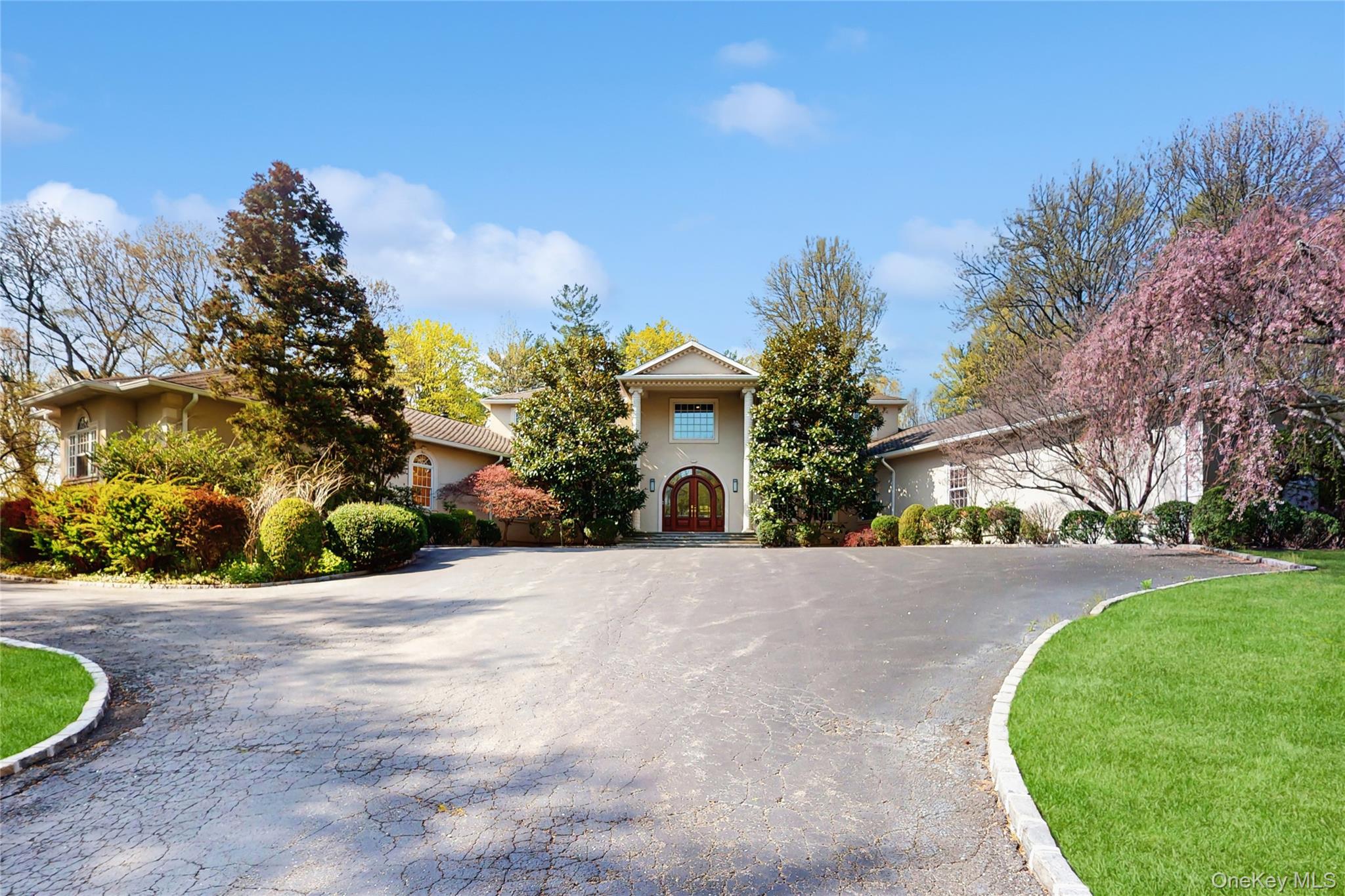 Tucked away on a serene private road just minutes from the storybook charm of Locust Valley, this Mediterranean-style Colonial is a true estate of distinction. Sited on 5+ pristine acres, seamlessly blends classic elegance with modern luxury. Designed with both grandeur and comfort in mind, the home features two gracious primary suites on the main level, a total of 6 spacious bedrooms, 5 full bathrooms, and one half bath. Soaring 10-foot ceilings enhance the sense of openness throughout, while rich oak hardwood floors provide warmth and sophistication in every room. The heart of the home is a massive chef’s kitchen, thoughtfully appointed for both entertaining and everyday living. A timeless oak-paneled library offers a refined retreat for work or leisure. The layout is perfectly made for making entertaining a seamless, enjoyable experience. Recently renovated, upstairs bathrooms, along with brand new HVAC systems, and a newly constructed three-car garage, ensure turnkey ease and modern comfort. Full partially finished basement, with walkout to outside. "The Last of the Mohicans" on a highly desirable private road in Matinecock, this extraordinary property offers rare privacy and elegance in one of Long Island’s most coveted enclaves. Close proximity to LIRR (train), renowned golf courses, and schools makes this a desired location. A truly unique offering that must be seen to be appreciated.