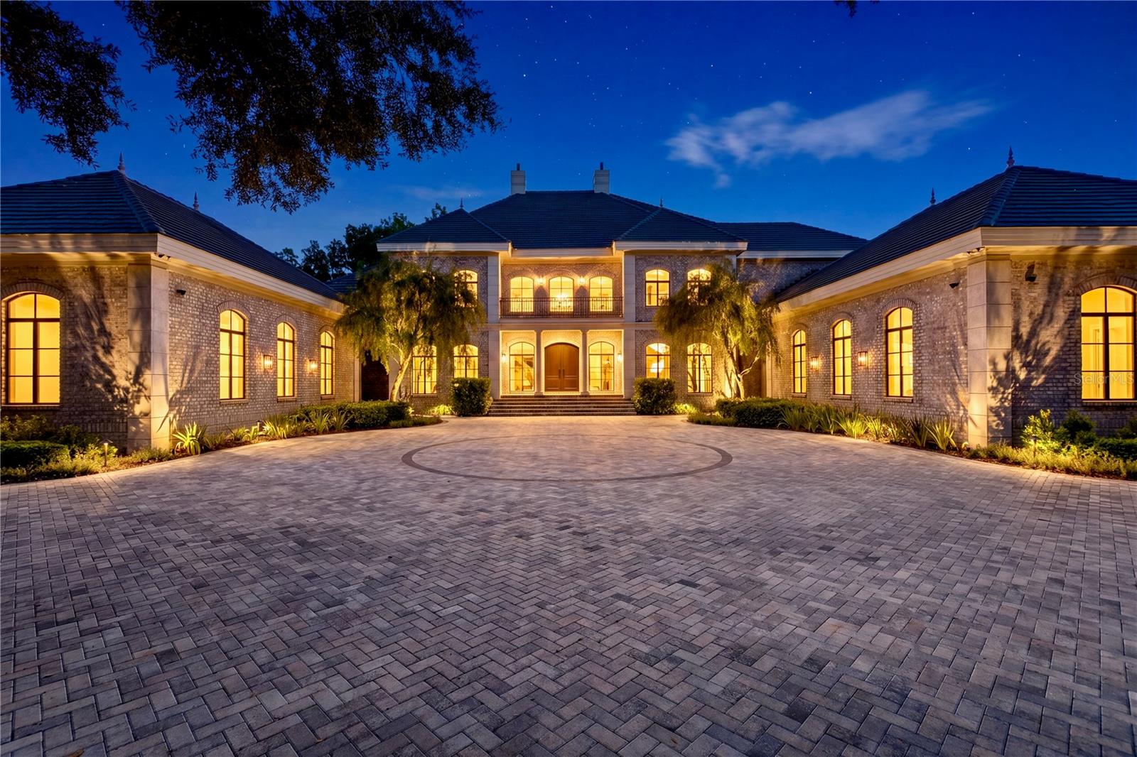 Exceptional opportunity to own one of Avila’s most breathtaking estates, located within Tampa Bay’s premier guard-gated golf and country club community. From the moment you arrive, this magnificent gated brick residence makes an unforgettable impression, offering an extraordinary setting on a premium golf course homesite with spectacular views and exceptional privacy. Completely remodeled with exquisite attention to detail, the estate showcases the finest finishes, exceptional craftsmanship, and numerous upgrades throughout. Encompassing an impressive 8,920 square feet of luxurious living space, the residence features 5 beautifully appointed Ensuite Bedrooms, a Golf Simulator Room, Bonus Room, Movie Room  and a 6 Car Garage. The outdoor living experience is equally remarkable, highlighted by a spectacular resort-style swimming pool and spa, Outdoor Kitchen and Fireplace  that truly create the perfect setting for entertaining, relaxing, and enjoying the Florida lifestyle. Every room of this exceptional estate has been beautifully transformed, beginning with new windows that fill the home with an abundance of natural light. Beautiful wood flooring flows throughout, creating a warm and inviting  backdrop for the home’s beautifully redesigned interiors. A dramatic two-story foyer, highlighted by a custom iron staircase, creates an impressive first impression and opens to the elegant formal living room with a fireplace. The spacious, open-concept floor plan provides an effortless flow from room to room, making the home ideal for both intimate gatherings and grand-scale entertaining. The formal dining room, enhanced by gorgeous designer lighting, provides an elegant setting for memorable dinners and special occasions. The completely redesigned kitchen is a true showpiece, masterfully designed with an uncompromising attention to detail. Custom designed  cabinetry is beautifully complemented by  quartz countertops, creating a timeless aesthetic. An exceptional collection of professional-grade appliances includes Wolf double ovens,  Sub-Zero refrigerators and Gaggenau induction cooktops, offering the perfect combination of beauty and performance. Generous preparation and an adjoining kitchen dining room make this truly the heart of the home.  The kitchen flows seamlessly into the  family room, creating an impressive yet inviting space designed for both everyday living and effortless entertaining. Anchored by a beautiful fireplace, the family room is enhanced by French doors that open to the estate’s spectacular outdoor living spaces. The downstairs primary suite is beyond compare and is the ideal sanctuary for privacy and comfort. The primary bathroom is finished with gorgeous cabinetry, a steam room and custom designed his and her closets. The outdoor living space includes, a newly designed swimming pool and spa that creates a private resort-style retreat, complemented by an outdoor fireplace and fully equipped outdoor kitchen. This exceptional indoor-outdoor setting provides the perfect backdrop for elegant entertaining, relaxed evenings by the fireplace, and year-round enjoyment of Florida’s beautiful climate. This estate in Avila with its unparalleled setting, exceptional amenities, and stunning golf course views offers a lifestyle that is simply beyond compare.