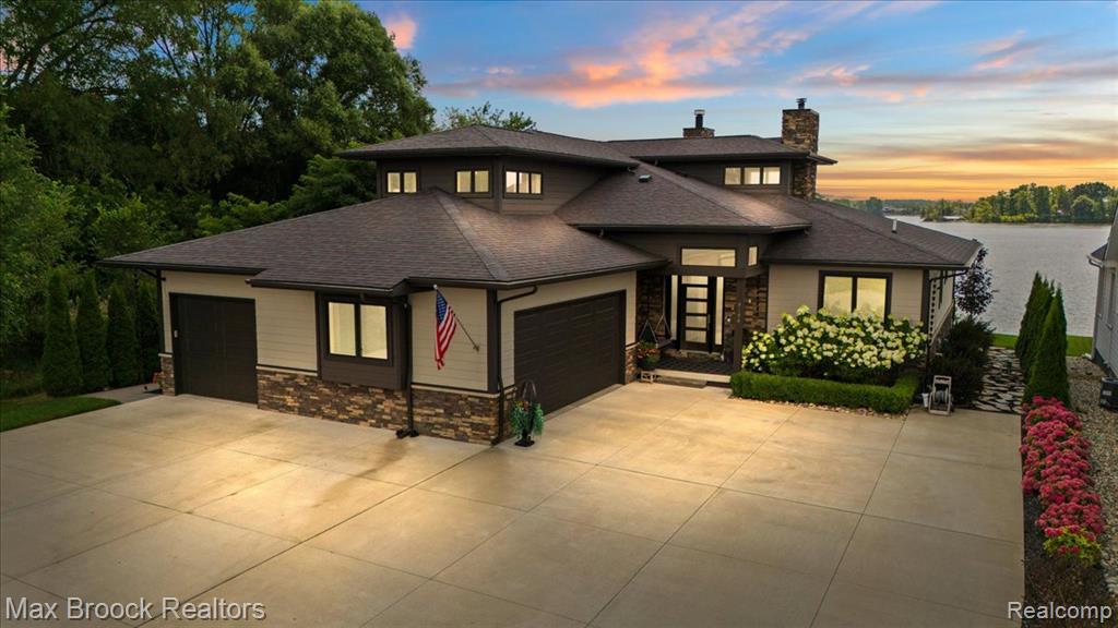 Experience the luxury of lakefront living with this magnificent custom built waterfront home. Perfectly nestled on coveted all sports Woodland Lake in one of the most sought after areas of Brighton, this truly one of a kind residence boasts an unparalleled 76 ft. of water frontage on a picturesque lot. The moment you walk through the front door you'll be mesmerized by the impeccable detail put into this home. Soaring ceilings greet you over striking custom flooring. Strolling through the immense great room, stunning lake views surround you at every turn. Your custom designed chef's kitchen has incredible space. Featuring top of line Kitchen-Aid appliances, custom cabinetry, massive range, an expansive custom island for entertaining, fireplace, lake views from every window, and a walkout that opens to a gorgeous terrace, it's an entertainers dream. The first floor Primary Suite is a sight to behold. Oversized and complete with it’s own incredible lake views, custom walk-in California closet and massive bath tiled floor to ceiling, you’ll never want to leave. The second level in this home is equally as impressive as the first. Featuring an open and flowing layout the second level hosts large bedrooms, lake views, full bath and a bonus room for a variety of accommodations. Not to be outdone, the exterior of this home is impeccable. Trex decking is front and center surrounding by Master Gardner designed landscaping, brilliant professional lighting, Gazebo, custom fireplace, and private lake views, it is the perfect place to host the largest event or most intimate gathering. Everything in this home is newer and with one of the largest and best positioned lots on the lake it won’t last long, come see it now before it’s gone!