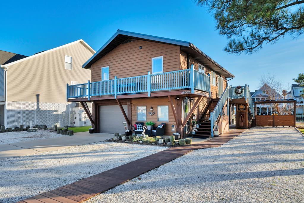 INCREDIBLE WATERFRONT WONDERLAND in Captain's Cove Golf & Yacht Club! This newly renovated 2 Bdrm/1.5 Bath Canal Front Home is in pristine condition, and also has a 1st Floor In-Law Suite! Totally TURNKEY, you will love the updates! With gorgeous Hardwood Floors in the Living Area, the owners made such amazing use of the space. This listing encompasses the main house ONLY, but adjacent Lot listed for $192k - BUY BOTH FOR $625K - ALL can be yours.  Lot is 5A1-1-946. Imagine your own Tropical Paradise w/Tiki Bar, Summer Kitchen, and more! Summer Kitchen & Crab Cookers convey, furnishings negotiable. Views of Chincoteague Bay, Rocket Launches, tons of wildlife - HEAVEN! Crab & Fish in your own Backyard.  ALL of this could YOURS, plus Captain's Cove Amenities!