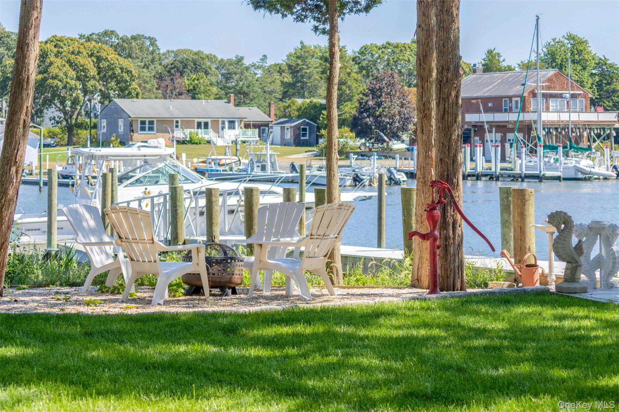 Creekfront Escape w/ 40' wide deep water floating dock! This stunning newly constructed waterfront home is perfectly situated on Meeting House Creek. With its large oversized dock and deep water access, this home is a boater's dream. Step inside to discover a spacious interior boasting 3 bedrooms, 3 full bathrooms, and a versatile flex room that can be used as a main floor en-suite bedroom or additional living space. The open concept great room features a chef's kitchen, dining area, and living room, creating the ideal space for entertaining. Upstairs, find two guest bedrooms, including one with a water-side balcony, a full bathroom, and a truly impressive master bedroom with an en-suite bathroom and water-side balcony. Outside, the rear yard offers a large stone patio, fire-pit, and a red brick walk-way that leads to the home's impressive deepwater dock. Located on Overlook Dr, a private road that juts out into the bay, you'll enjoy fantastic water access to the Great Peconic Bay and all it has to offer.