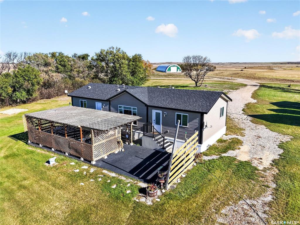Opportunity to own 10 acres less than 15 minutes NW of Saskatoon just east of Bergheim Estates with limited neighbors. This very private parcel is located at the end of the road with only has one neighbor it is a very quiet serene setting with great views in all directions. The home is a 2021 built modular with 3 bedroom, and 2 full baths.  It has an open floor plan with an upgraded maple kitchen and granite countertops.  The home also has central air and and HRV system.  Outside you will find a private oasis with a rubber paved patio under a pergola perfect for sunbathing or a soak in the hot tub.  The property is completely serviced including natural gas , municipal water on a drip system with the tanks and pressure system housed in one of the heated out buildings and a generac natural gas back up generator. There are numerous out buildings all with power to them.  The possibilities are endless with opportunity for vast storage or converting some of the buildings to heated work shops. The outbuildings include a 40x56x16 foot conventionally framed building on a concrete footing that could easily be insulated, heated and have a concrete floor poured to use as a dream shop, a 40x60 wooden arch framed building on a concrete footing, another good candidate for a heated shop and a 46x70 steel archrib quonset great for cold storage of boats, RV's ect. In addition there is a 24 x24 detached garage with concrete floor and electric garage door opener that is heated with an oil furnace and a 18x24 heated garage that is home to the pressure system and also set up as a small workshop.