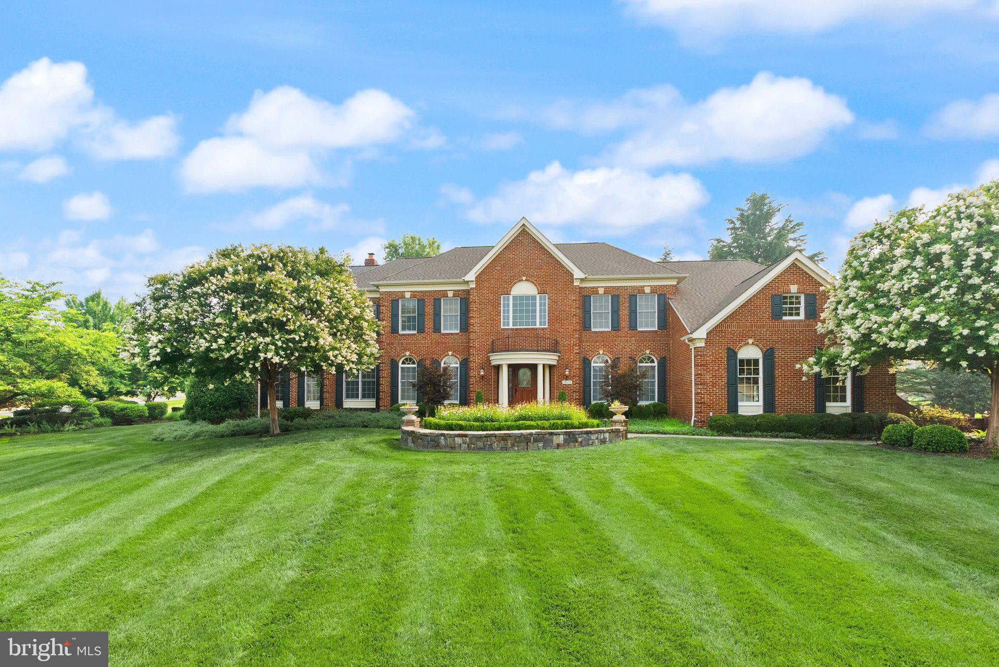 Freshly painted custom estate with a 3-car garage, offering an incredible combination of luxury, craftsmanship, and resort-style living on one of the largest premium lots in Belmont. ***A grand marble foyer welcomes you into an elegant interior highlighted by wide-plank hardwood flooring, custom millwork, detailed decorative finishes, wrought iron stair balusters, and abundant natural light. The thoughtfully expanded floor plan includes multiple custom additions that significantly enhance the home's size, functionality, and appeal.***At the heart of the home is a spectacular chef's kitchen featuring premium Viking and Sub-Zero appliances, a six-burner range with pot filler, Advantium double wall ovens, custom cabinetry, stone countertops, and exceptional workspace. The adjoining sunroom addition creates the perfect gathering space with a cozy gas fireplace and picturesque views of the outdoor retreat.***The expansive family room features slate flooring, custom built-ins, a gas fireplace, and ample space for entertaining. A richly appointed main-level library with built-in shelving offers the ideal home office or study, while the impressive conservatory addition is surrounded by walls of windows that flood the home with natural light. The formal dining room showcases custom moldings, a tray ceiling, and a butler's pantry complete with wine cooler.***The luxurious primary suite is a true private retreat featuring a coffered ceiling, gas fireplace, spacious sitting room, expanded custom closet space, and a spa-inspired bath with heated tile floors, elegant columns, illuminated dome ceiling, oversized shower, and premium finishes throughout.***Extensive additions include a three-story expansion creating additional space for the conservatory, golf simulator room, and expanded primary suite closet; a two-story addition adding the sunroom and card room; and a separate two-story addition incorporating an oversized laundry room and additional finished lower-level living space with full bath.***The fully finished lower level offers an incredible entertainment experience with a massive recreation room, dedicated theater area featuring a 4K digital projector and Polk Audio sound system, custom wet bar, game room, card room, exercise room, golf simulator room, workshop, den/guest bedroom, two full bathrooms, and abundant storage. All installed audio/visual equipment conveys, including multiple televisions, projectors, speakers, and entertainment systems.***Outdoor living is equally impressive. The nearly one-acre homesite has been transformed into a private natural stone oasis featuring extensive hardscaping, a tranquil stream, koi pond, outdoor stone fireplace, built-in stone cooking and grilling area, jacuzzi, mature landscaping, irrigation system, and multiple gathering spaces designed for year-round enjoyment. The setting offers exceptional privacy and one of the largest lots in Belmont.***Additional highlights include three gas fireplaces, custom window treatments throughout, epoxy-coated garage flooring, upgraded lighting and fixtures, extensive technology enhancements, and countless custom details rarely found in today's market.***Residents of Belmont Country Club enjoy exceptional amenities including Arnold Palmer Signature golf course, modern fitness center with classes, 7 tennis courts, and pickleball, three swimming pools, upscale dining at Lee's Table & Tavern, and year-round social events and community activities. The HOA also provides lawn care, trash and recycling, high-speed internet, and cable TV, making homeownership easy and low maintenance. Prime Loudoun County location convenient access to: Washington Dulles International Airport, Belmont Chase shopping, and dining. One Loudoun lifestyle center and Lansdowne Town Center. With nearby access to the Silver Line Metro and major commuter routes, this location blends luxury living with everyday convenience.