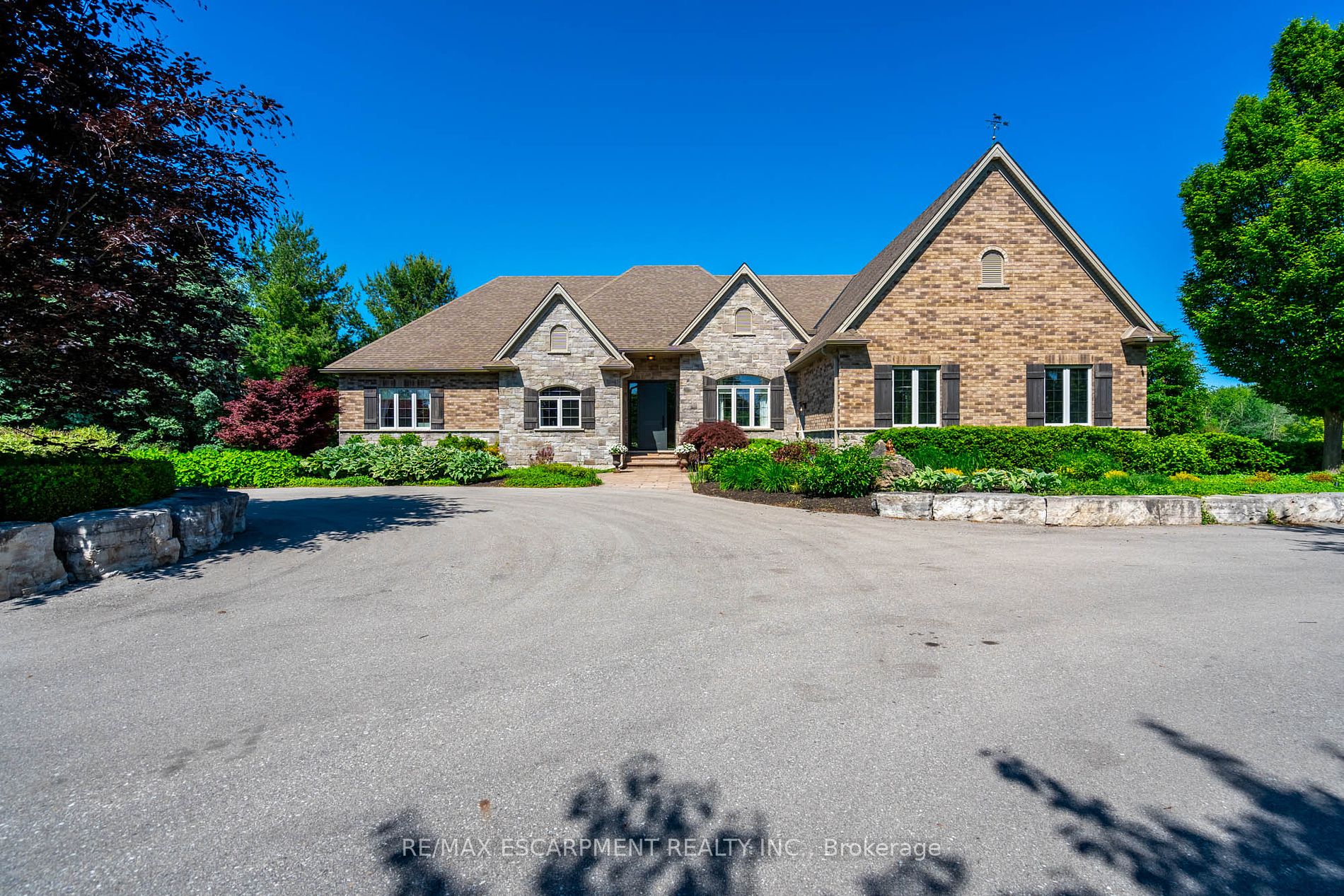 The perfect hobby farm does exist, and youll find it right at 1068 Wyatt Road in a prime east Flamborough locale. Here, you have the best of both worlds  a postcard worthy setting on a quiet country road yet just minutes to town and close to major highways. This gorgeous 27-acre parcel offers a true rare package  a custom executive bungalow, well-maintained barn, fenced paddocks, bush and a pond. Step inside the 2,800 square foot home, and youll immediately notice the private, stunning views from every side. The open concept floor plan offers large principal rooms with the details that luxury commands  soaring 9 ceilings, in wall-sound system, crown molding, and engineered hardwood flooring. The kitchen is the hub of the home, with quartz counters, heated floors, a six burner Wolf gas stove and access to the study. The oversized primary bedroom has private views of the expansive property, and is complete with a walk in closet and large 5 piece bathroom  with a soaker tub and heated floors! The two secondary bedrooms are generous-sized and share a jack and jill bathroom. The fully finished lower level has two additional bedrooms, a full bathroom with steam shower and a second full kitchen. It also has a separate entrance through garage. Looking for peace and privacy  it has it all! RSA.