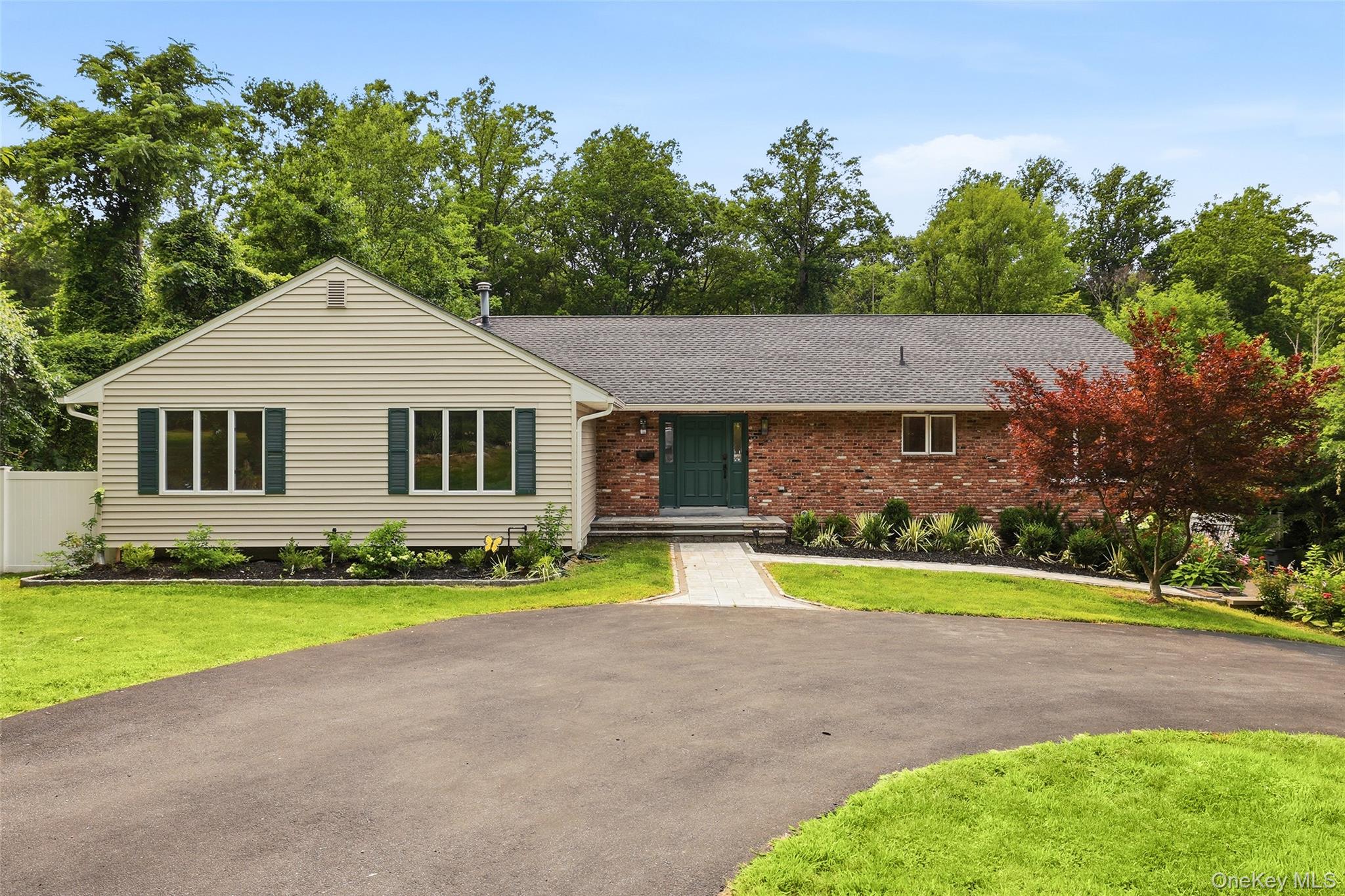 Recently renovated to perfection, this meticulous ranch is set on a flat, park-like acre just minutes from town, train, schools, and more. Offering the ease of one-floor living with exceptional space, this move-in-ready home features a dramatic step-down living room with soaring ceilings, a stunning wall of custom built-ins, and doors to a brand-new maintenance-free deck. A spectacular chef's kitchen with top-of-the-line appliances, custom cabinetry, and under-cabinet lighting. A private office/guest suite includes a custom Murphy bed and renovated full bath. The bedroom wing offers two additional bedrooms, a beautifully updated hall bath, and a luxurious primary suite with deck access and a spa-like bath with double vanities and soaking tub. The finished lower level provides outstanding bonus space with a new custom bar, recreation room, gym, playroom, and finished storage. Enjoy the expansive deck overlooking the magnificent level acre, ideal for entertaining and everyday living. Oversized driveway with abundant guest parking. A rare opportunity to own a turnkey home in an exceptional location.