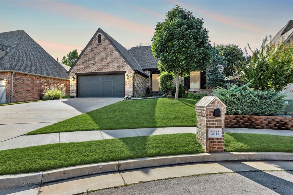 Welcome to this stunning home in Edmond’s desirable Birnam Woods addition—where modern design, timeless craftsmanship, and thoughtful details come together seamlessly. From first glance, the home’s impressive curb appeal, lush landscaping, and inviting entry make a striking impression. Inside, an open-concept layout creates a natural flow between living, dining, and kitchen spaces, ideal for entertaining and everyday living alike. The spacious living room features a corner brick fireplace, ceiling beams, wood floors, and large windows that fill the space with natural light. The adjoining dining area is generously sized, offering plenty of room for family meals or hosting dinner parties. The modern white kitchen is the true heart of the home, showcasing a large center island with seating, sleek cabinetry with abundant storage, extensive counter space, stainless appliances with double ovens, and elegant finishes that make both cooking and entertaining a pleasure. The private primary suite offers a relaxing retreat, complete with a tray ceiling and a beautifully appointed ensuite bathroom featuring double vanities, a walk-in shower, a large soaking tub, and a spacious walk-in closet. Two additional bedrooms are thoughtfully designed with ample storage and easy access to a well-appointed hall bath. The dedicated office provides the perfect space for working from home, studying, or a creative studio—offering flexibility to fit your lifestyle needs. Step outside and enjoy your own private outdoor oasis. The covered patio with an outdoor firepit sets the scene for cozy evenings, morning coffee, or weekend gatherings with family and friends. Tesla in garage charger. Located in the heart of Edmond, Birnam Woods is known for its beautiful homes, mature trees, & convenient proximity to top-rated schools, shopping, dining, and entertainment. This home perfectly balances modern elegance, comfort, and function—making it an ideal choice for today’s discerning buyer.  Welcome Home!