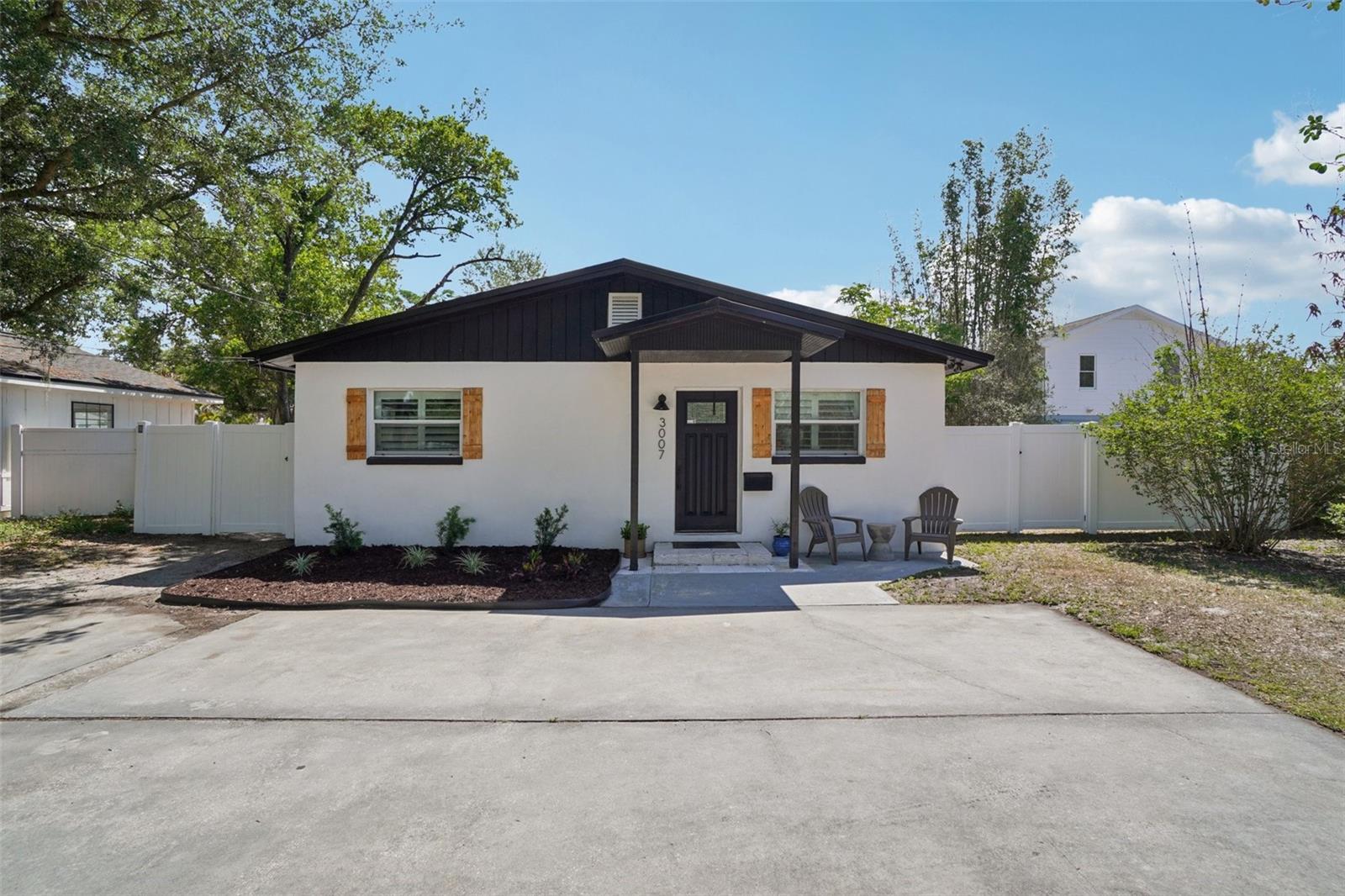 Welcome to this stunningly renovated, move-in-ready gem in the heart of Tampa Heights. Blending modern sophistication with cozy bungalow vibes, this 5-bedroom, 3-bathroom home at 3007 N Woodrow Ave offers an expansive, open-concept floor plan designed for effortless entertaining and comfortable living.  Brand new standing seam METAL ROOF (April 2025)!The heart of the home is a chef-inspired kitchen featuring dramatic exotic stone countertops, professional-grade stainless steel appliances, and sleek shaker cabinetry that flows seamlessly into the light-filled living area. Natural light pours in through a custom skylight and oversized windows, highlighting the maintenance-free large-format tile flooring that spans the main living spaces.The primary suite serves as a true sanctuary, complete with a private sliding glass entry to the backyard and a spa-like ensuite bathroom. Indulge in the blissful freestanding soaking tub, or enjoy the convenience of a dual vanity and a massive walk-in shower with high-end matte black fixtures. Outside, the fully fenced-in yard provides a private oasis, perfect for weekend BBQs or enjoying the Florida sunshine. Located just minutes (.7 miles) from the vibrant Armature Works, the Riverwalk, and Downtown Tampa.  Super convenient to Publix, Sprouts, Tampa International, so this home places you right in the center of the city's most sought-after dining and entertainment. Don't miss your chance to own a piece of the Heights!