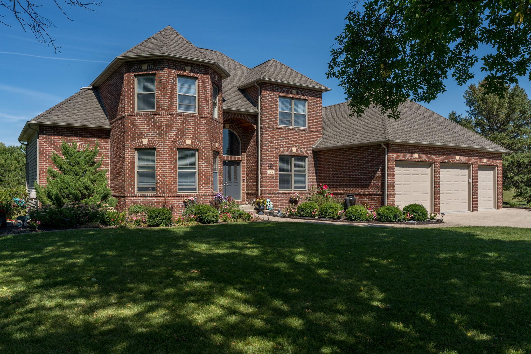 Move-in ready and situated on a beautifully landscaped spacious lot, this immaculate home offers everything you've been dreaming of! Featuring 5 bedrooms, 3 bathrooms, and a 3-stall garage, this property boasts exceptional design details, including elegant arched openings throughout. The well-maintained exterior showcases a large deck, patio, firepit area, inground sprinkler system, and a pet containment system, making it perfect for outdoor enjoyment and relaxation. Step inside the double-door vaulted entry to find an open-concept formal dining room complemented by a 2-sided Kasota stone fireplace, which can be enjoyed from both the great room—complete with a balcony above—and the vaulted living room. The custom kitchen, updated by Cherry Creek in 2021, is a chef’s delight, featuring a center island with seating, pendant lighting, stainless steel appliances, tile flooring, and a breakfast nook with access to a deck and a 3-season screened porch. The primary bedroom suite is a serene retreat, offering a private bathroom with a separate soaker tub, walk-in closet, and a walk-in shower. The main level also includes an office, a laundry room, and a convenient half bath. Upstairs, you'll find three additional spacious bedrooms and a full bathroom, while the lower level provides additional living space, including an open-concept rec room with a wet bar, dining area, and family room featuring a cozy corner gas fireplace. The 5th bedroom, another full bathroom, and a flexible office space—which could also serve as a guest bedroom—complete the lower level.