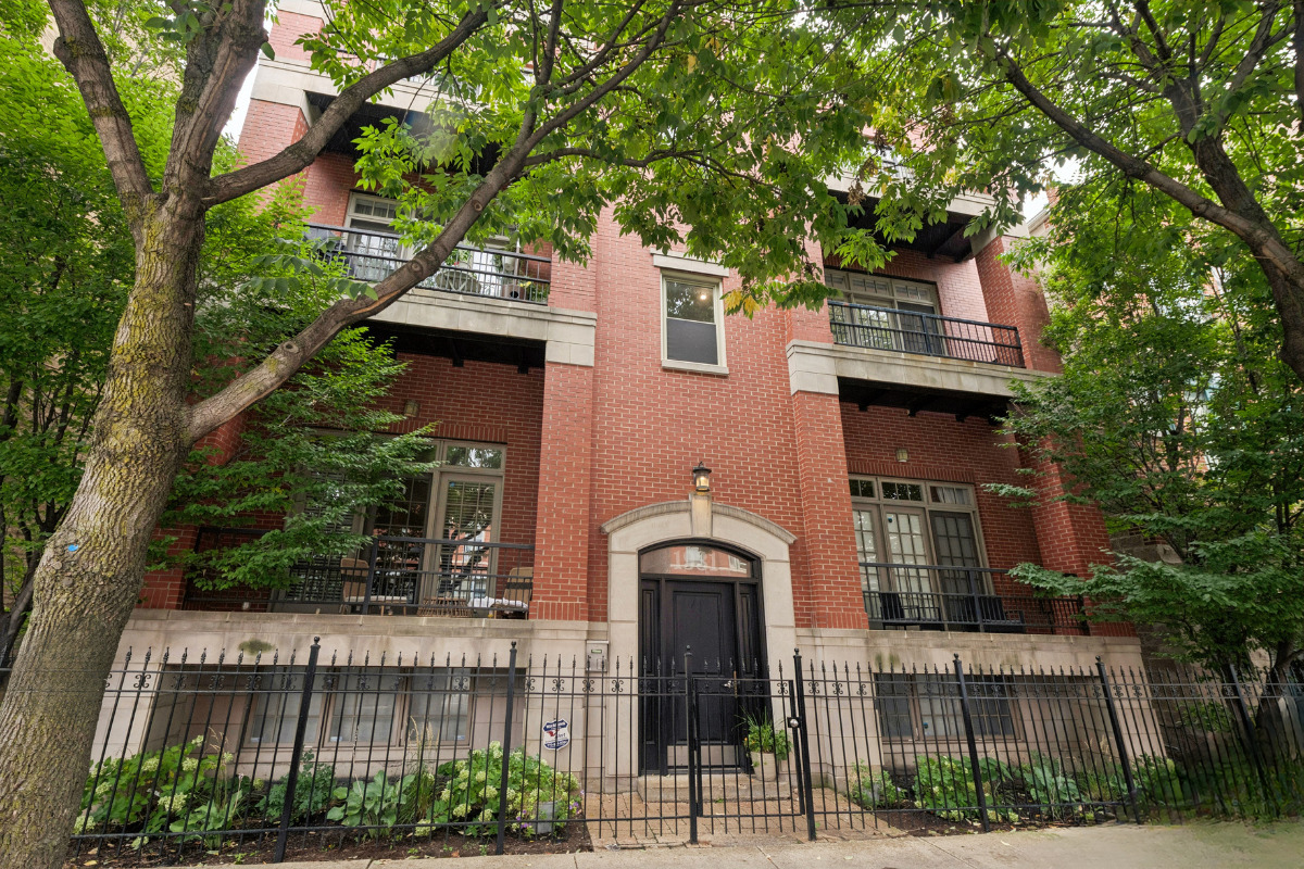 Welcome to this sun-filled 2-bedroom, 2-bathroom Bucktown condo in a boutique elevator building that offers modern finishes and everyday conveniences. The open living and dining area features soaring 10-foot ceilings, oak hardwood floors, custom built-ins, a Carrara marble tiled gas fireplace, and a new wine fridge. Large windows and a front balcony overlook the tree-lined street, creating a quiet retreat in the heart of Damen Avenue. The kitchen is both stylish and functional, with crisp white cabinetry, quartz countertops and backsplash, ample storage, and stainless-steel appliances. The spacious primary suite offers a full wall of closets, motorized blackout shades, and a luxurious en-suite bath with marble countertops, dual sinks, a soaking tub, and a separate shower. A large second bedroom and a generous guest bath make the home as practical as it is inviting. Additional highlights include in-unit laundry with a side-by-side washer and dryer, an attached garage parking space, central heating and cooling, and extra storage in the building. The 606, Churchill Park, neighborhood restaurants, boutique shopping, cafes, and vibrant nightlife are all nearby. Public transit options include the Damen Blue Line, Armitage and Damen buses, and the Clybourn Metra station. This condo is the perfect blend of style, function, and location, ready for you to move in and enjoy.