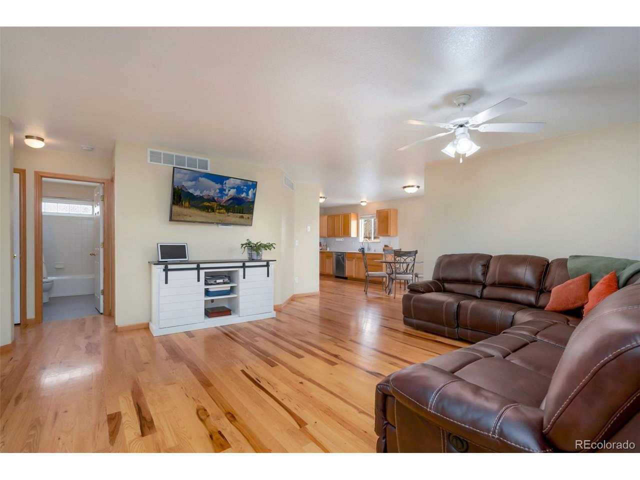 Beautiful ranch home with warm wood floors and a bright, functional layout designed for comfortable living and easy entertaining. A welcoming tile entry opens to a spacious living room and flows into the large kitchen and dining area, where all appliances are included.The main level features a generous primary suite complete with a gorgeous 3/4 bath, walk-in closet, and the TV is included. Two additional bedrooms and a full bathroom complete the main floor.Downstairs, the sun-filled finished basement provides fantastic additional living space, featuring a large family/recreation room (TV and surround sound system included), plus a kitchenette with refrigerator, dishwasher, dining area, and breakfast bar-perfect for entertaining or extended living. The basement also includes a fourth bedroom, beautifully updated full bathroom, laundry area, and additional storage space.Step outside to a fully fenced backyard, complete with an adorable dog house for your four-legged friends. The yard is serviced by non-potable irrigation water provided by the HOA, helping keep your outdoor watering costs affordable.