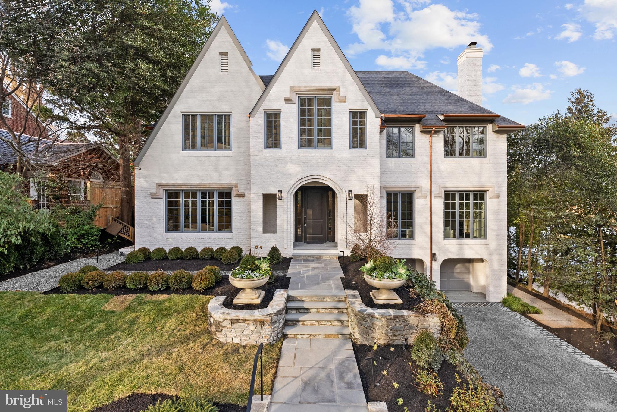 Located in the heart of the estate section of Wesley Heights on a private quarter-acre lot set gracefully back from the street, 4433 Cathedral Avenue is a newly transformed brick Tudor by Madison Investments that masterfully blends timeless architecture with today’s most refined luxuries. With soaring 10-foot ceilings and an exceptional main-level flow designed for elegant entertaining, the home features one of the neighborhood’s largest kitchens and adjoining family rooms—completely rebuilt as part of a top-to-bottom renovation including all-new windows, wide-plank flooring, mechanical systems, chef’s kitchen, and spa-inspired baths.Additional highlights include a screened porch (ideal for seamless indoor-outdoor living), a sun-filled walkout level opening to expansive flagstone terraces, and a spectacular mudroom with custom built-ins and laundry directly off the two-car attached garage. The private owner’s suite is a true retreat, offering two custom walk-in closets, a luxurious oversized bath, a cozy fireplace, and a dedicated office.Spanning approximately 9,570 square feet across four beautifully finished levels with 7 bedrooms, 6 full baths, and a powder room, the residence is complemented by manicured gardens, mature trees, and multiple outdoor entertaining terraces. This extraordinary Wesley Heights offering delivers estate-level scale and sophistication just moments from neighborhood dining, boutique shopping, and Horace Mann ES.