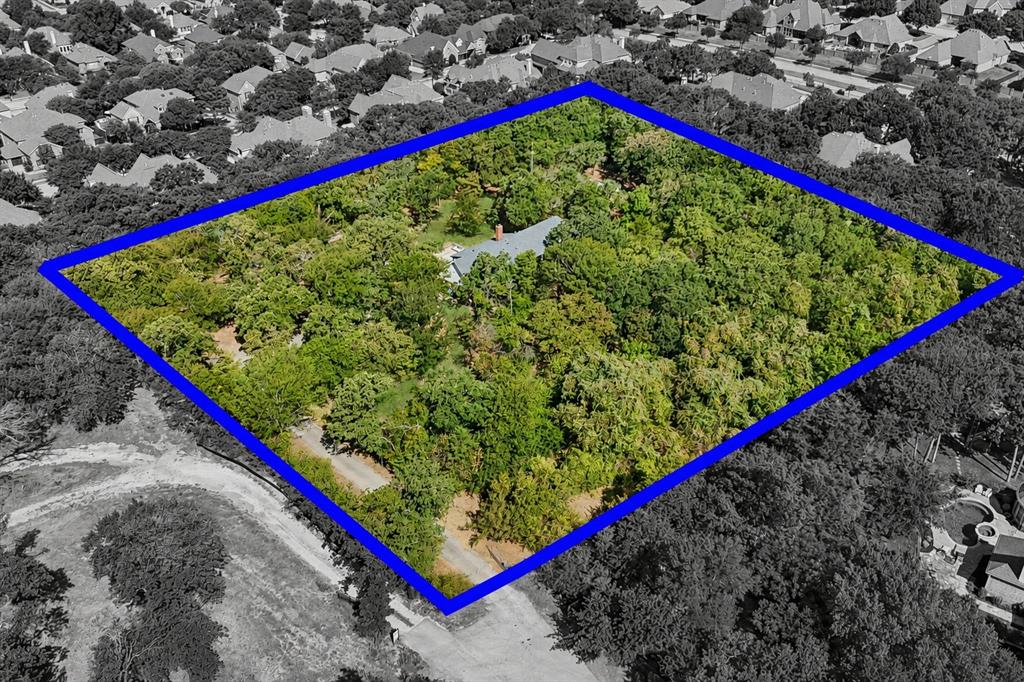 At the end of a quiet cul-de-sac, a tree-lined drive leads to a beautiful updated home on 2.3 private acres — a rare opportunity to enjoy as-is, build a dream home, or potentially divide into two homesites, all minutes from shopping, dining, top-rated schools, and conveniences. Recent updates include a new roof and gutters, HVAC system, and three remodeled bathrooms. The primary suite is a retreat, with a white oak ceiling, custom California Closets, a sitting area, and a renovated bath with custom cabinetry and an oversized dual-head shower. One downstairs living area, with its own full ensuite bath could serve as a second primary suite. A flex room with a built-in Murphy bed and desk can serve as an office, nursery, guest room, or hobby room. Upstairs features two bedrooms, one with a kitchenette; ideal for guests, older children, or multigenerational living. A spacious formal dining room is ready for holidays and gatherings, while the front porch and upper balcony invite you to slow down and take in the morning sunrises. Outside is where this property becomes truly special: mature oaks, open lawn, generous space between neighbors, and no HOA create a private, park-like setting that is increasingly hard to find. Gather around the fire pit with log seating, tend your garden, keep chickens in the existing chicken house, bring your horse, or simply enjoy the owls, songbirds, and quiet country evenings. With 2.3 acres to roam, there’s even room for a little backyard disc golf - something not many Keller homeowners can claim. An alpaca farm and bee farm on the same road add even more charm to the country setting. Visitors almost always have the same reaction: 'I had no idea a place like this existed in Keller. It feels so country and removed from this city, while restaurants, stores, and everyday necessities are so close.' Privacy, acreage, freedom, charm, and convenience all in one remarkable setting. The best of both worlds; a property that rarely comes along.