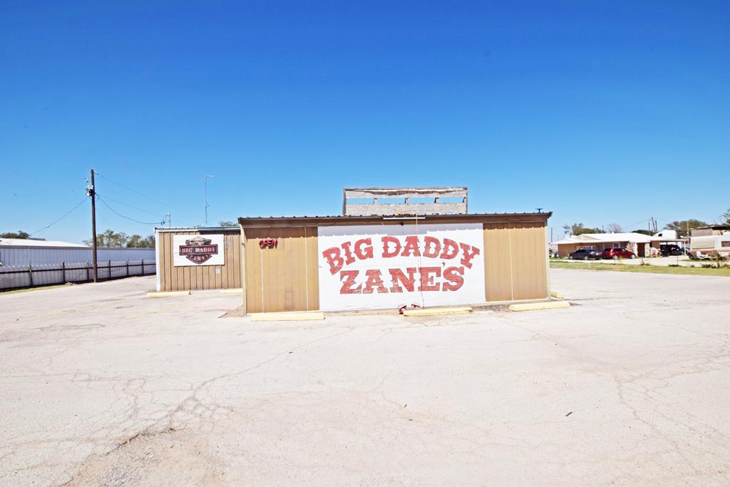 The property features retail parking, the building, and 2 trailers toward the back of property that could be used for offices or additional income. Its current use is a bar with fenced in yard Nice buildings for additional storage . IIt also has a space for RV and setup.  This is really a great deal with a Motivated seller.  The property could be used for many differnt options.. Call A Realtor and start your business!