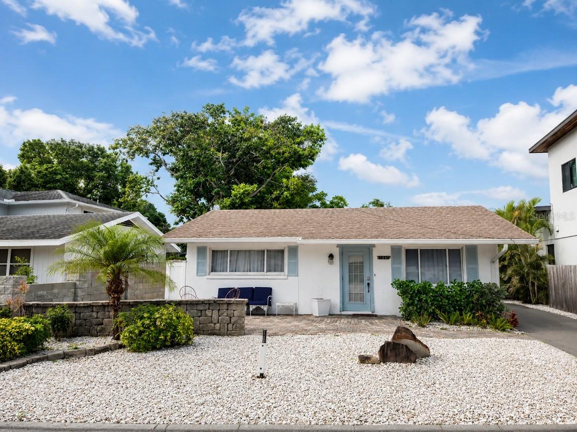 Live in one of Sarasota’s most desirable neighborhoods! Priced to sell. This charming home offers two generously sized bedrooms plus a versatile third space that can serve as a sunroom, office, or private in-law suite/studio. This additional area includes its own bathroom, kitchenette, closet, and separate rear entrance—perfect for guests or rental potential. Inside, you’ll find a cozy layout with a welcoming kitchen nook and comfortable living area, ideal for relaxing and unwinding. The home has been thoughtfully updated with a remodeled kitchen, a newer roof (2018), granite vanity top and sink with brushed nickel fixtures (2020), a brand-new water heater (2025), upgraded lighting (2025), and numerous additional improvements throughout. Enjoy your morning coffee on the inviting front porch or entertain and relax on the back patio. The backyard features a two-car carport, storage sheds, and a newly completed, eye-catching stone fence that adds both ambiance and privacy. Conveniently located just minutes from downtown Sarasota, shopping, dining, and the world-famous Siesta Key Beach, as well as other nearby beaches, this home offers both comfort and accessibility. Additional highlights include RV parking and multi-family zoning, providing excellent flexibility and investment potential. Schedule your private showing today and experience everything this beautiful home has to offer!
